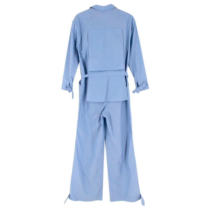 Rosie Assoulin End-on-end cotton-poplin jumpsuit

- Utility inspired silhouette
- Asymmetric pockets
- Tie to cuffs and waist
- Peplum design to back
- Zip up front
- Wide leg

Materials:
100% Cotton

Made in New York with imported