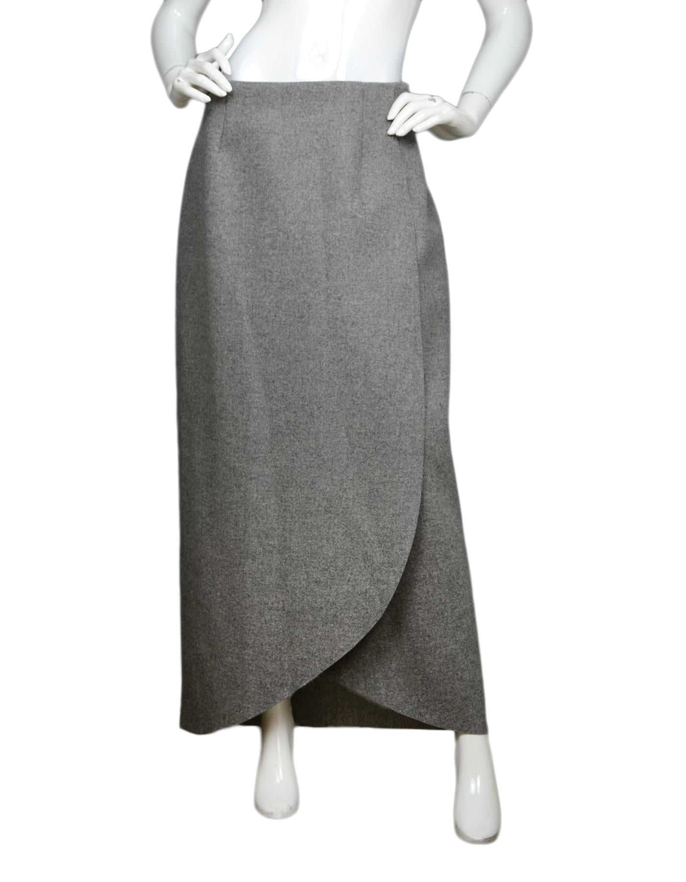 Rosie Assoulin Grey Wrap Wool-Flannel Maxi Skirt NWT Sz 10

Made In:  New York, USA
Color: Grey
Materials: 98% virgin wool, 1% nylon, 1% elastane 
Lining: 100% silk
Closure/Opening: Hidden side zipper with hook eye 
Overall Condition: Excellent