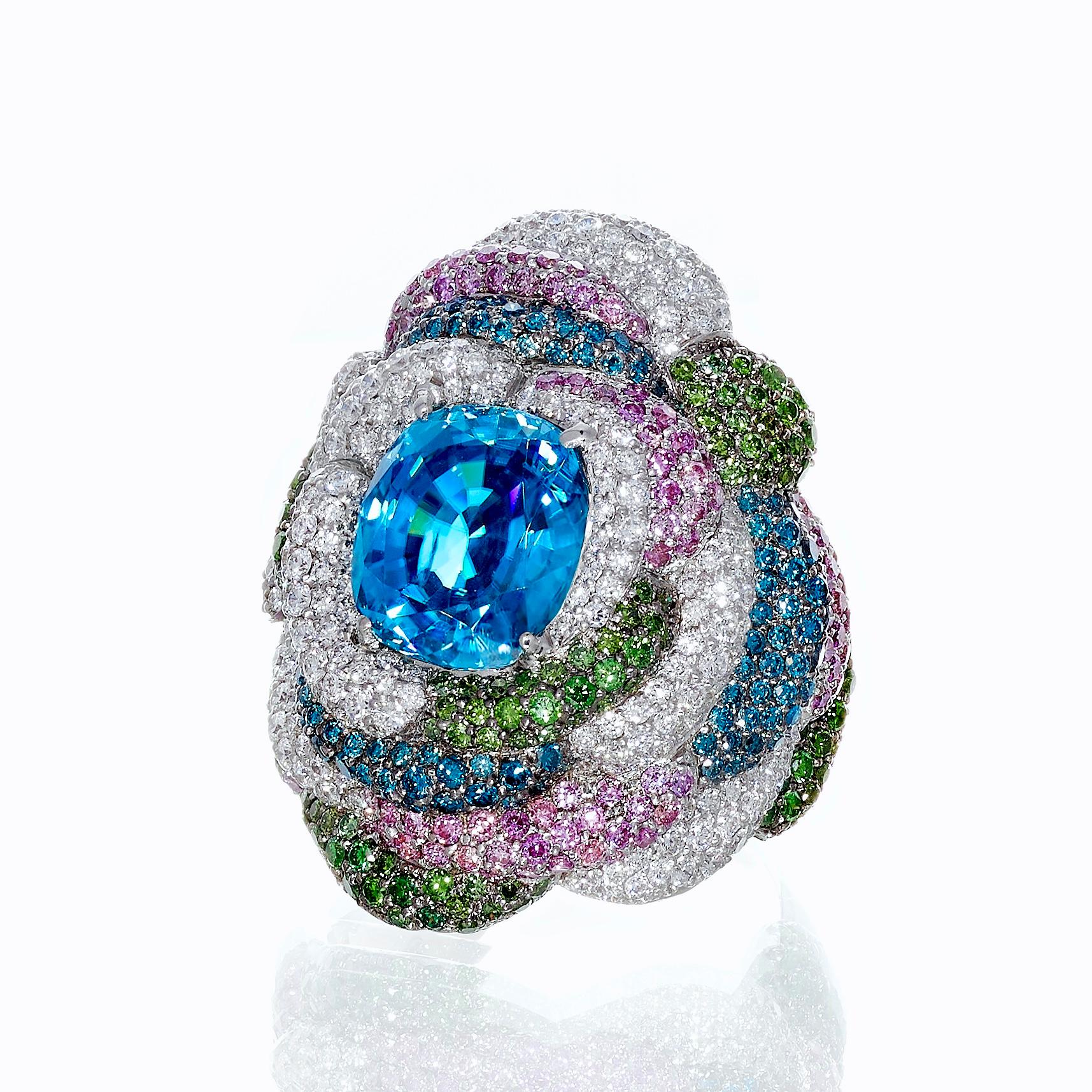 Rosior Contemporary Cocktail Ring set in White Gold with:
- 1 Cushion Cut Blue Zircon weighing 7,16 ct;
- 261 F Color, VVS Clarity Diamonds weighing 1,49 ct;
- 167 Green Diamonds weighing 1,08 ct;
- 124 Blue Diamonds weighing 0,81 ct;
- 147 Pink