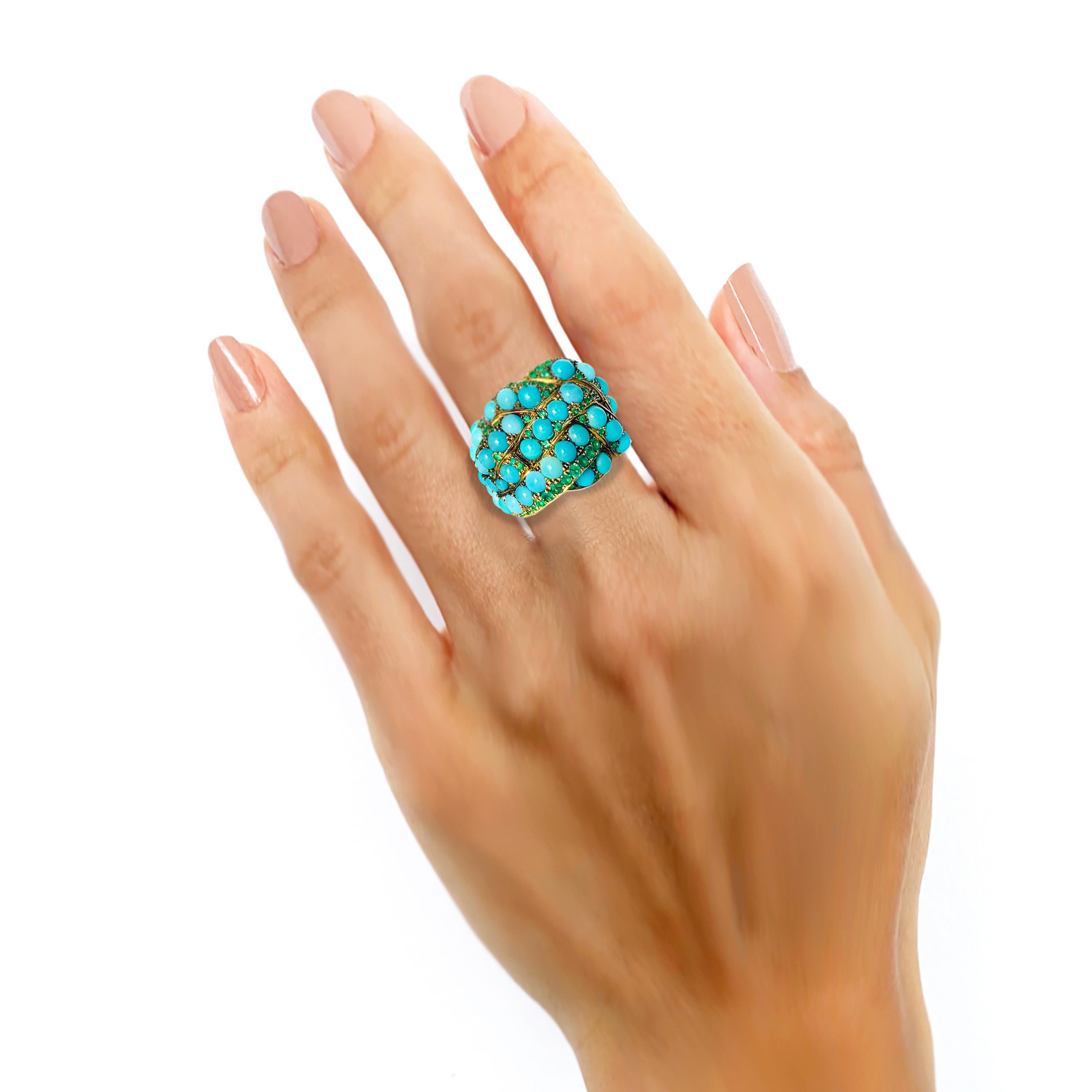 Rosior by Manuel Rosas 19.2k Yellow Gold Cocktail Ring, Hand Chiseled and set with:
- 49 Round Cabochon Turquoises with 9,57 ct;
- 97 Emeralds with 0,98 ct. 
Can be sized.
Black rhodium finnishing.
This unique piece comes with a Certificate of
