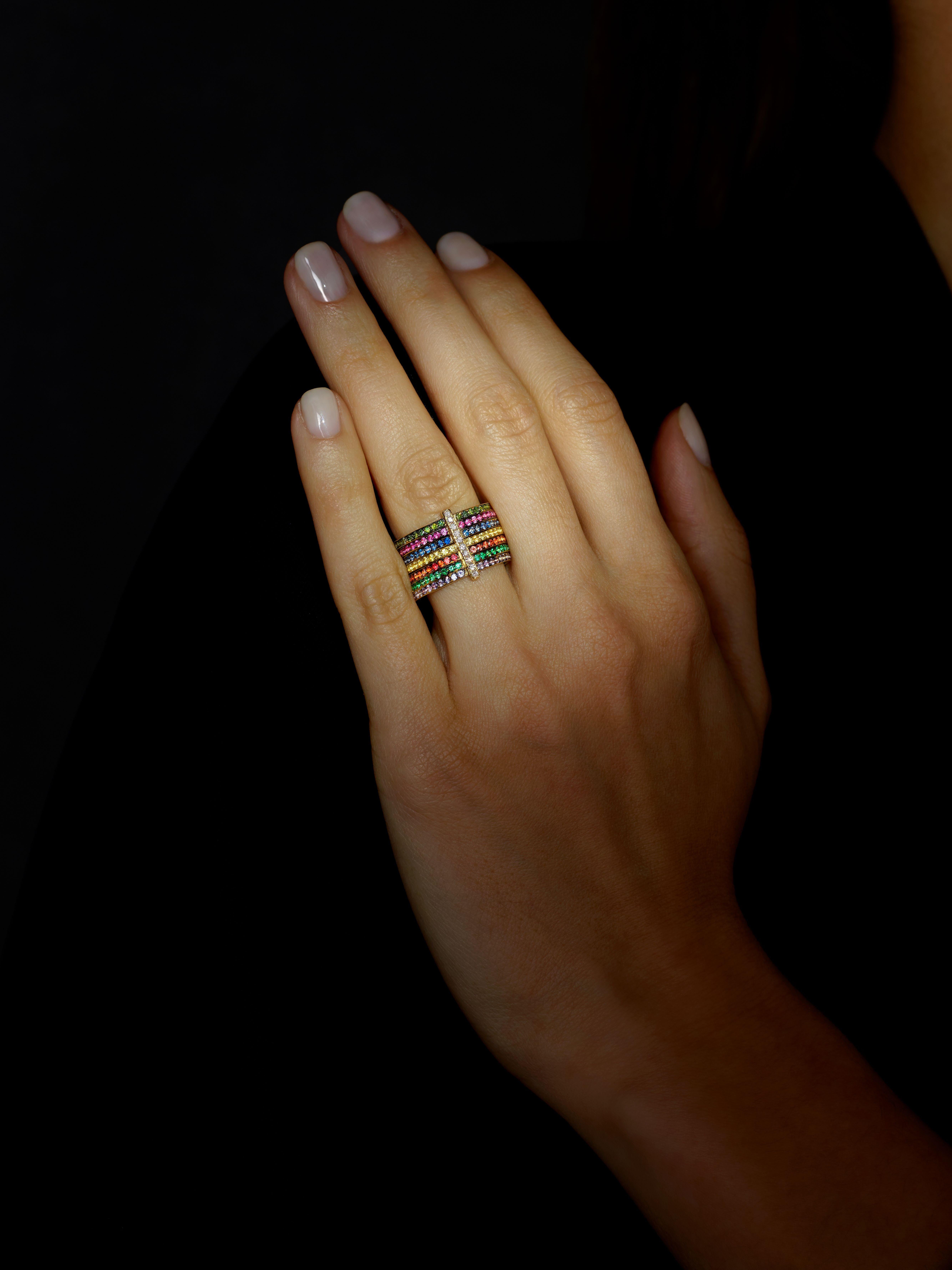 A one-off Multi-band Cocktail Ring by Rosior Portugal. It consists of seven individual gold rings unified by a diamond set bar.
This ring is set with:
- 10 certified Natural Diamonds, color F, VVS clarity weighing 0,09 ct;
- 20 green Diamonds