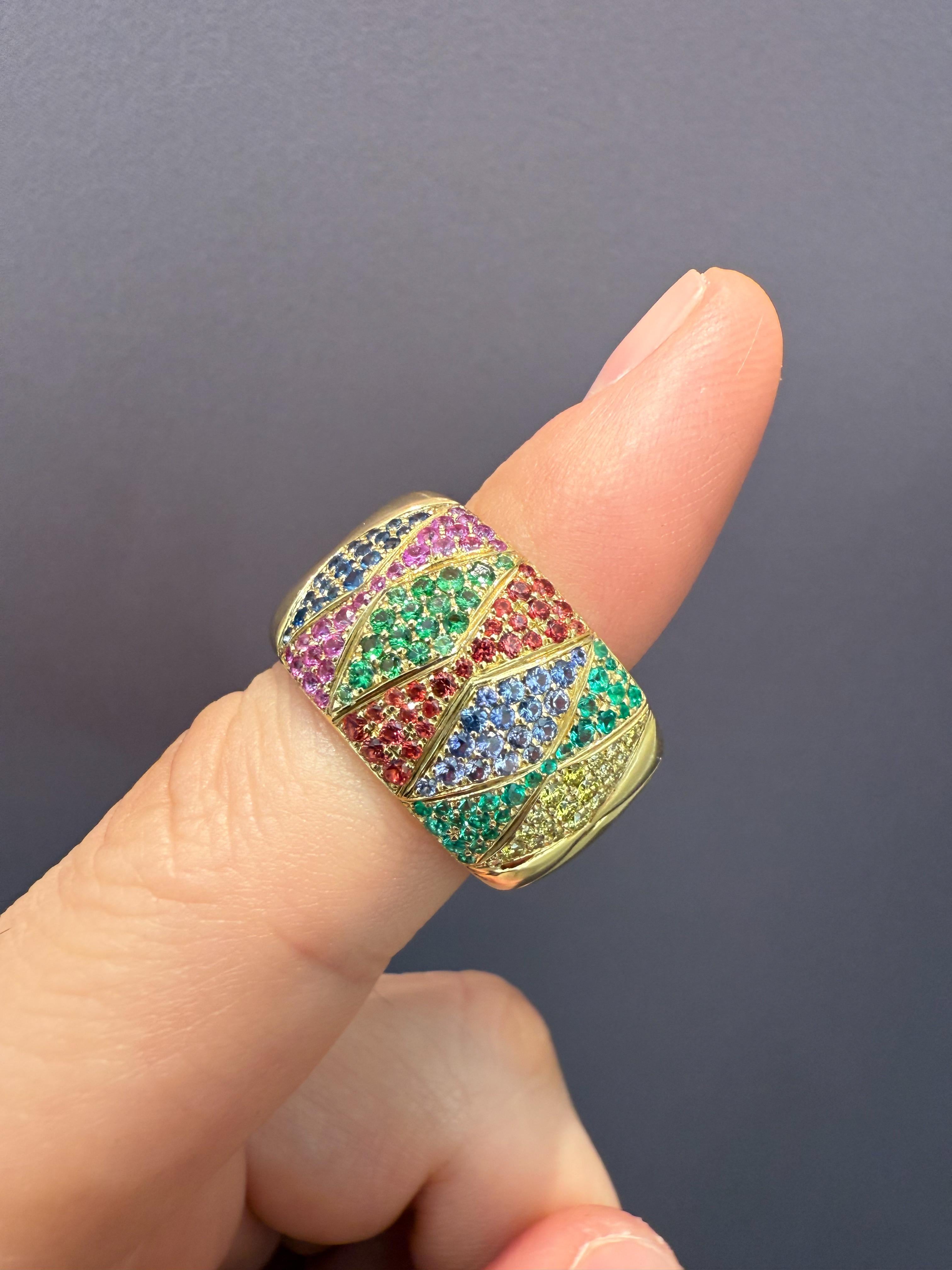 A Colorful Ring by Rosior, representing snake's skin, set with:
- 19 Yellow Diamonds weighing 0,20 ct; 
- 26 Emeralds weighing 0,14 ct;
- 18 Tsavorite Garnets weighing 0,25 ct; 
- 23 Pink Sapphires weighing 0,28 ct;
- 26 Orange Sapphires weighing