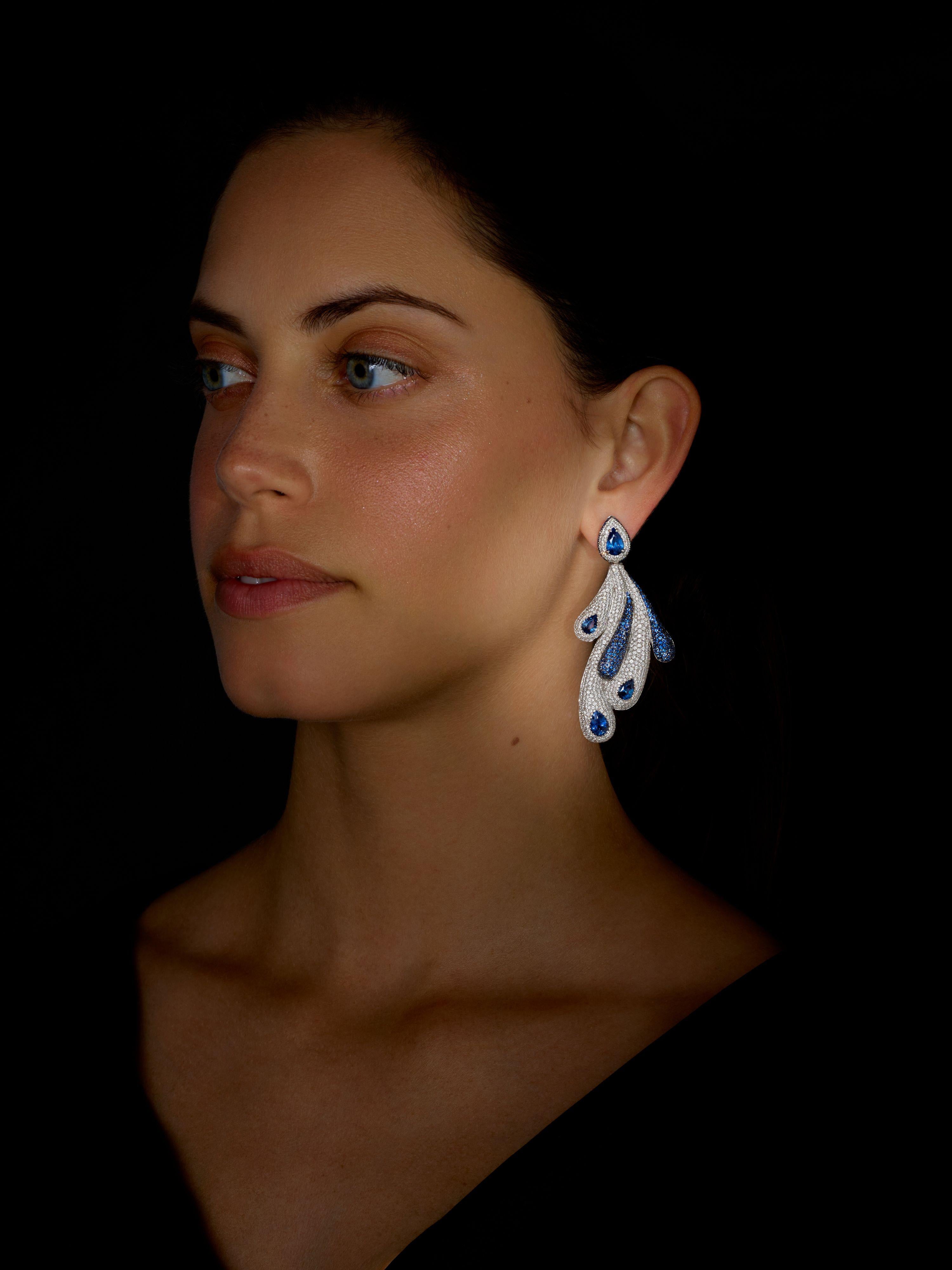 Long Dangle Earrings made in 19.2K White Gold by Portuguese jeweller Rosior.
These earrings are set with:
- 8 Pear Cut Ceylon Blue Sapphires weighing 8.72 ct;
- 1157 F Color, VVS Clarity Diamonds weighing 7.19 ct;
- 496 Blue Sapphires weighing 4.53