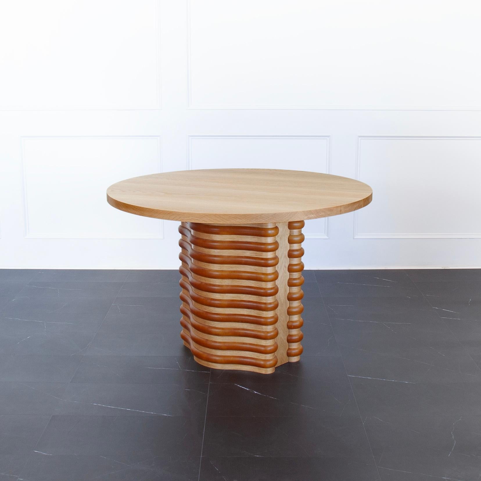 Roslin Pedestal Table by Crump and Kwash 

Features a solid wood table top with acrylic sealer / solid wood and leather wrapped ribs / adjustable leveling feet 

Size: 
48