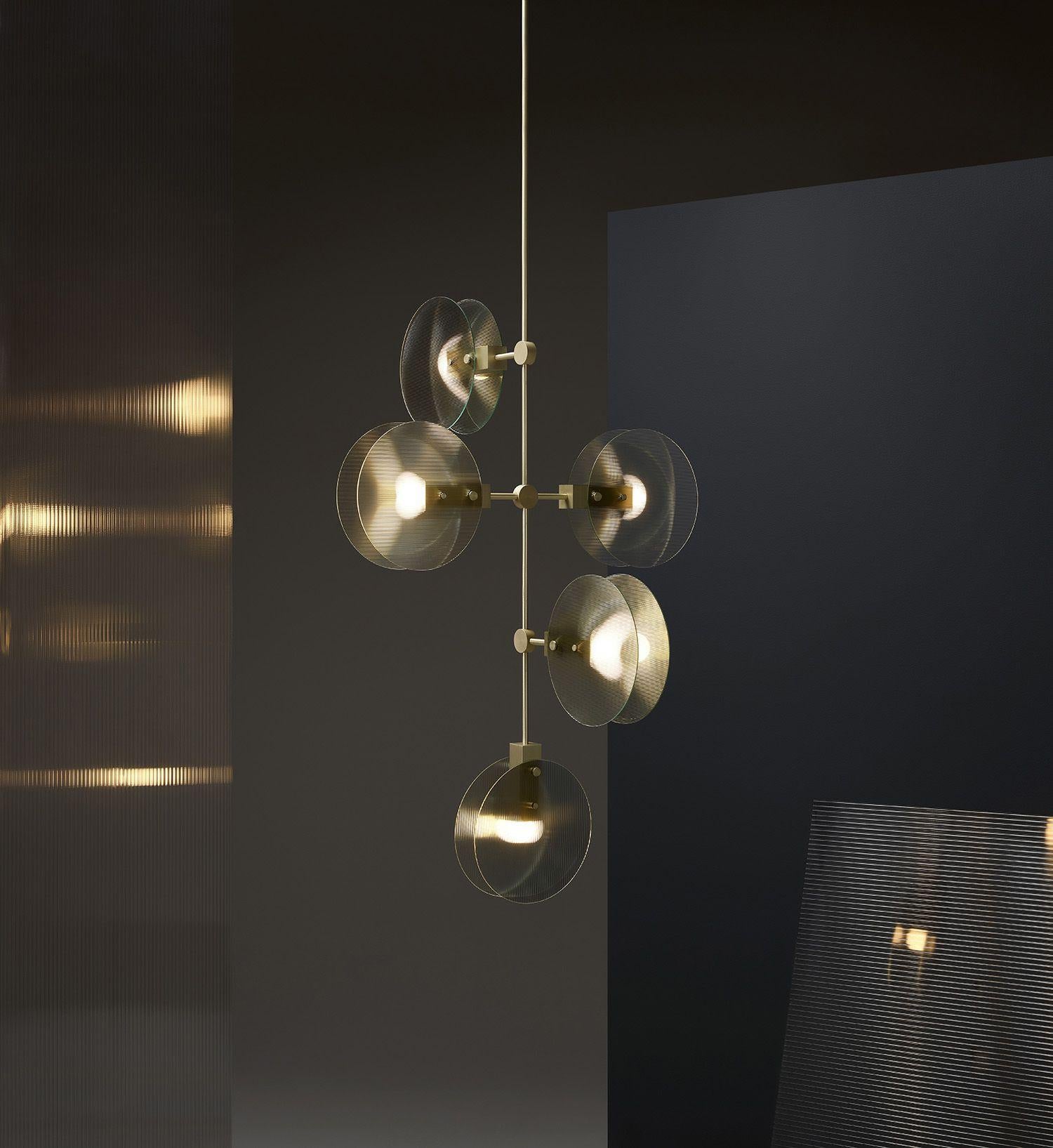 The Nebulae Collection is inspired by the diffusion of both natural and LED light. The geometric machined forms coupled with the fluid glass discs creates a balance between the elements.

The chandelier can be composed in a variety of hanging