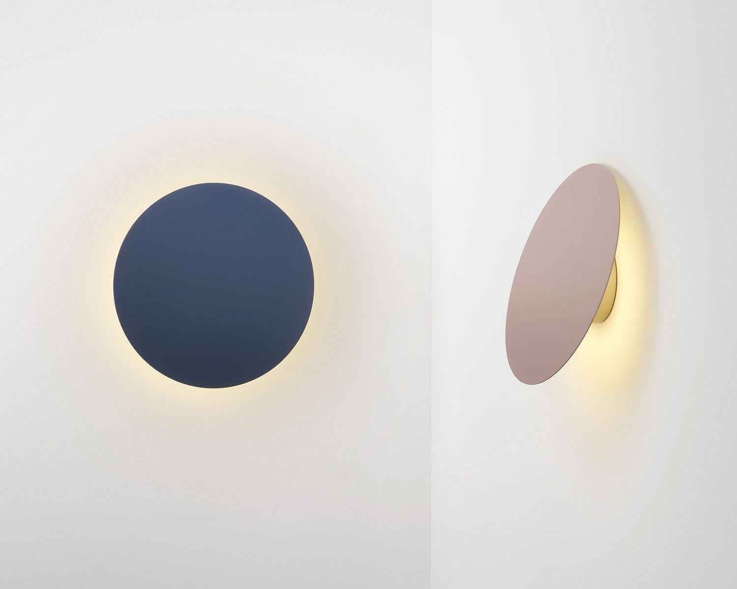 The circular motif of the polar is synonymous in its minimal operative form. The product utilizes a unique hinge joint allowing the shade disc to pivot up or down, softly directing the light output as desired. Polar Wall's anodized gold wall canopy