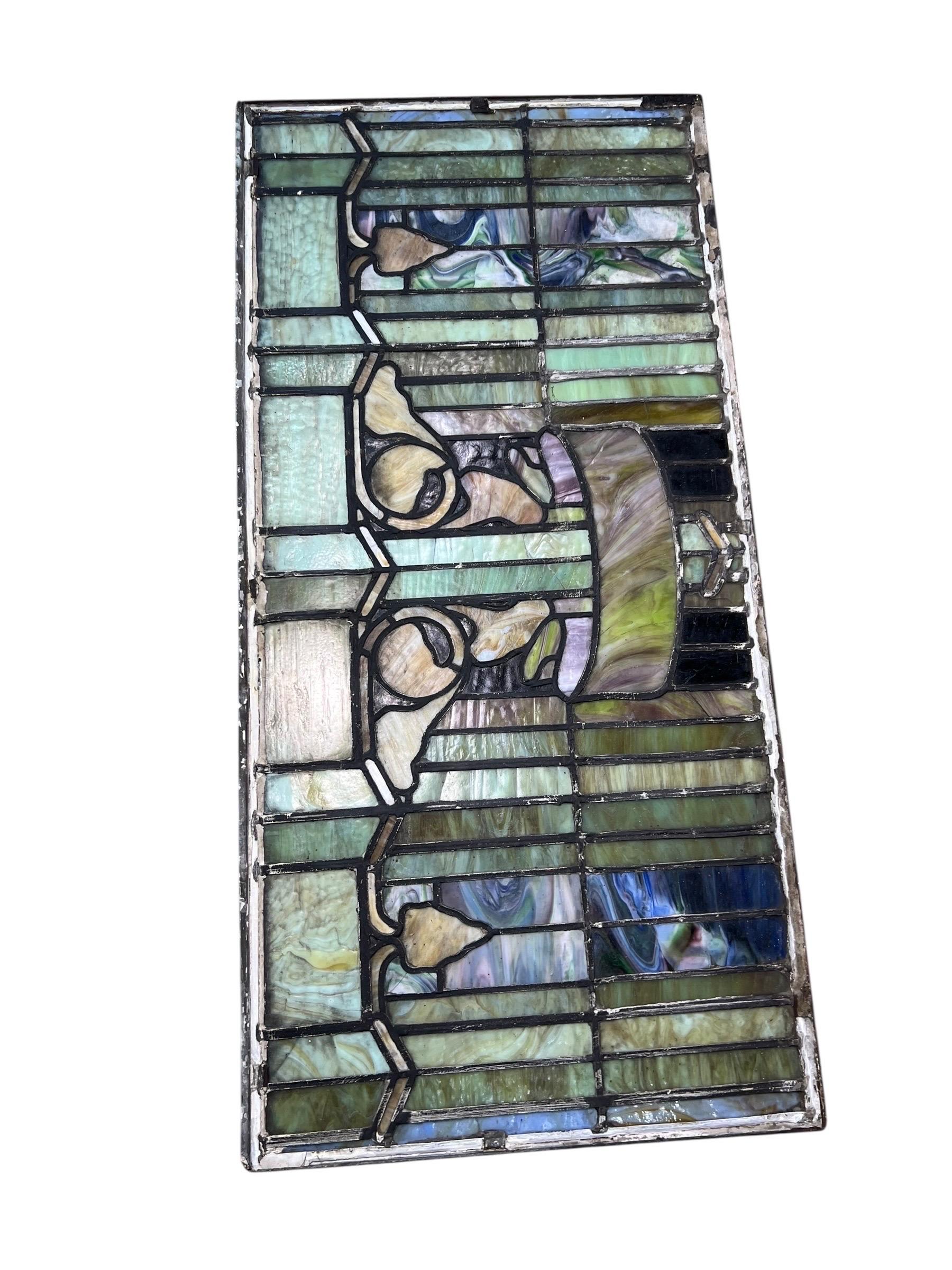 For sale is this very fancy well done stain glass window made by Rossbach and Sons in 1910