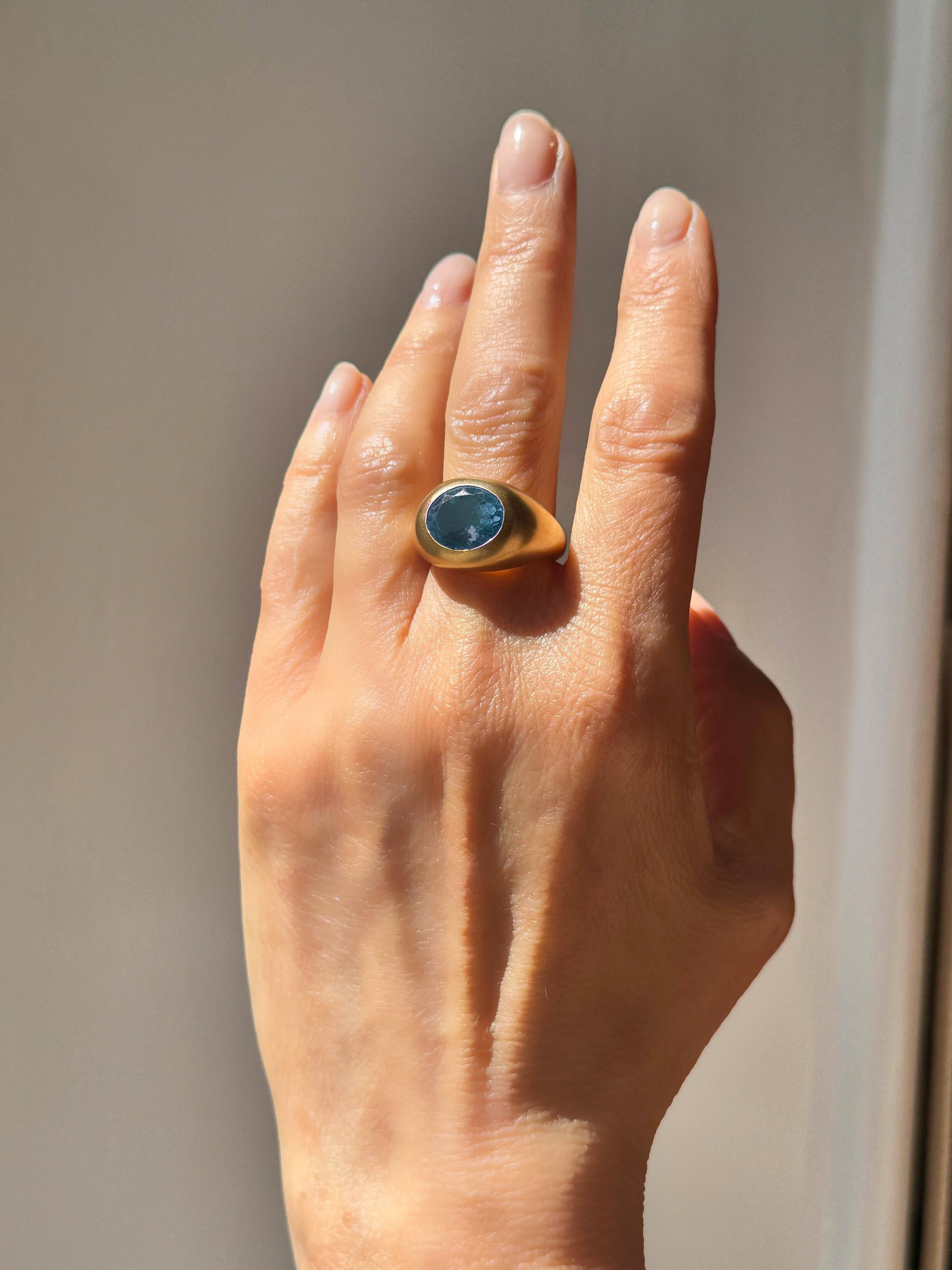 Fashion ring designed by Rossella Ugolini, 18k yellow gold domed ring, handcrafted in Italy. Embellished with a Blue Topaz gemstones faceted oval cut (10 x 8 mm) in solid 18K yellow gold with a satin finish. The unisex ring is very streamlined and