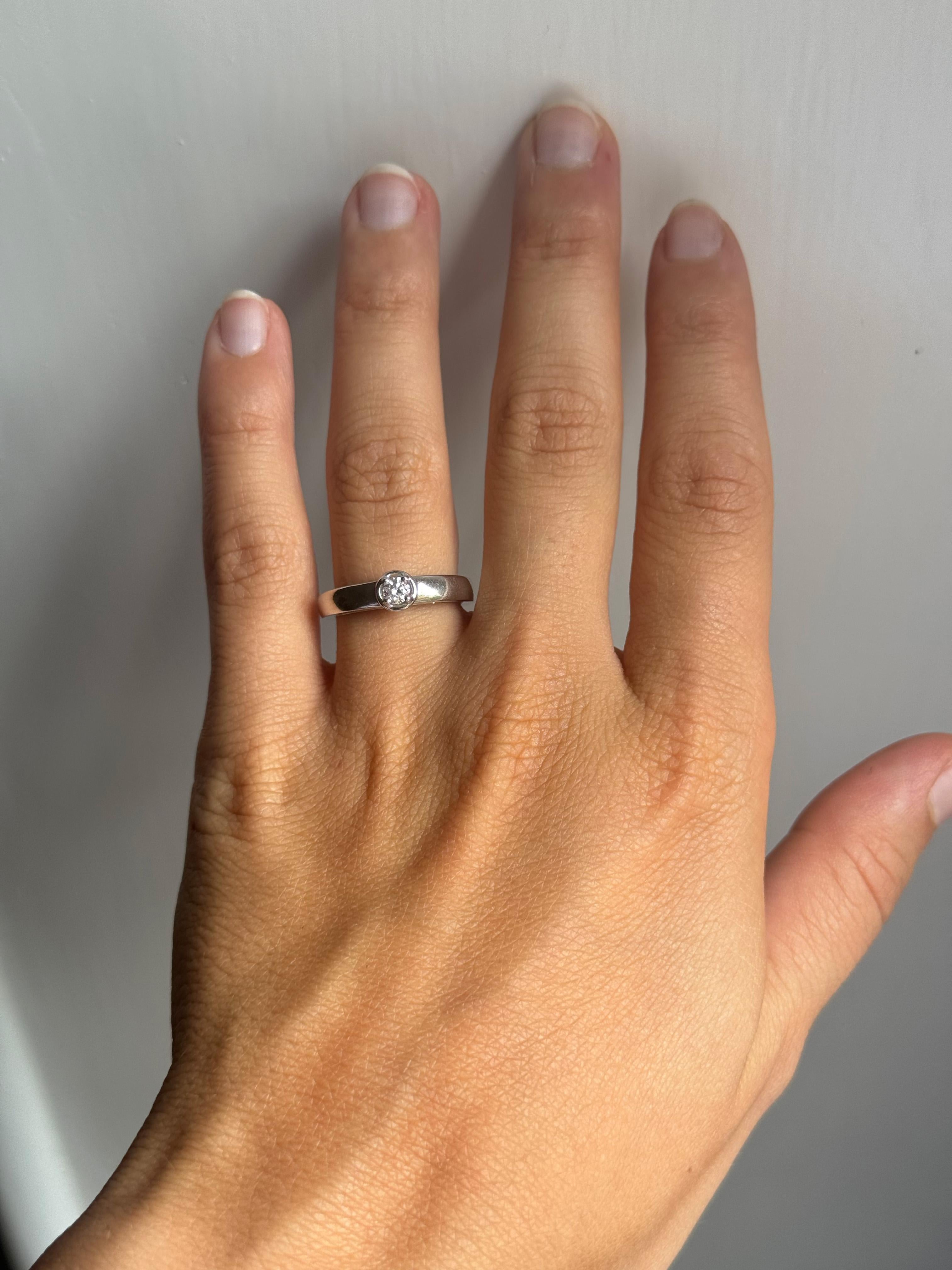 Rossella Ugolini 18k White Gold Ring with a 0.20 ct Central White Diamond, G Color, VS1 Clarity. This handmade Italian ring is a size 6.25 (US) and is resizable.
 It features a smooth, slightly domed 4mm band, with the diamond held at the top by