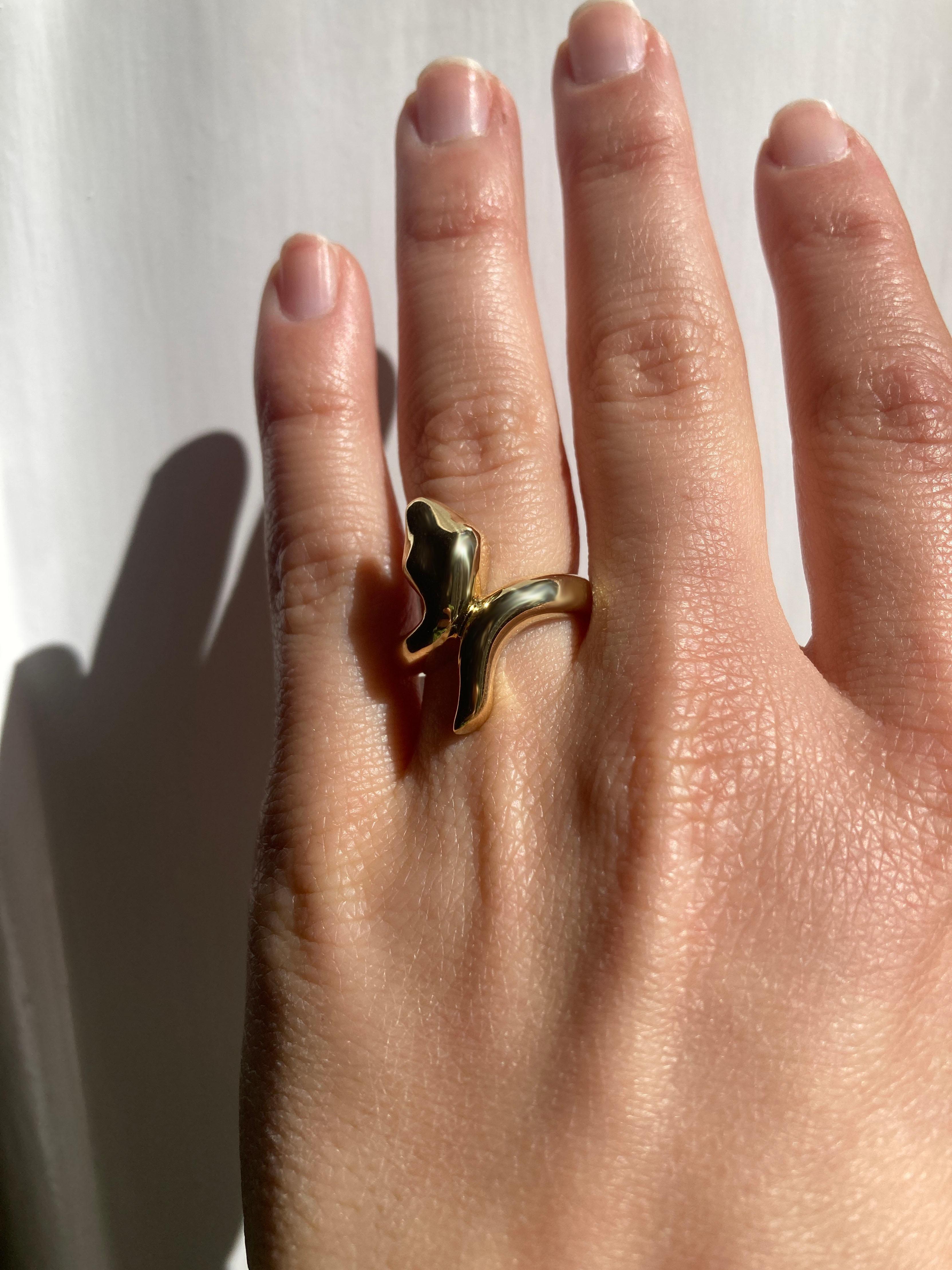 Rossella Ugolini Bold Snake ring, meticulously handcrafted in 18k Yellow Gold. This exquisite piece boasts a captivating design where the sinuous snake elegantly wraps around the finger, with its head and tail seamlessly connected in a single line,