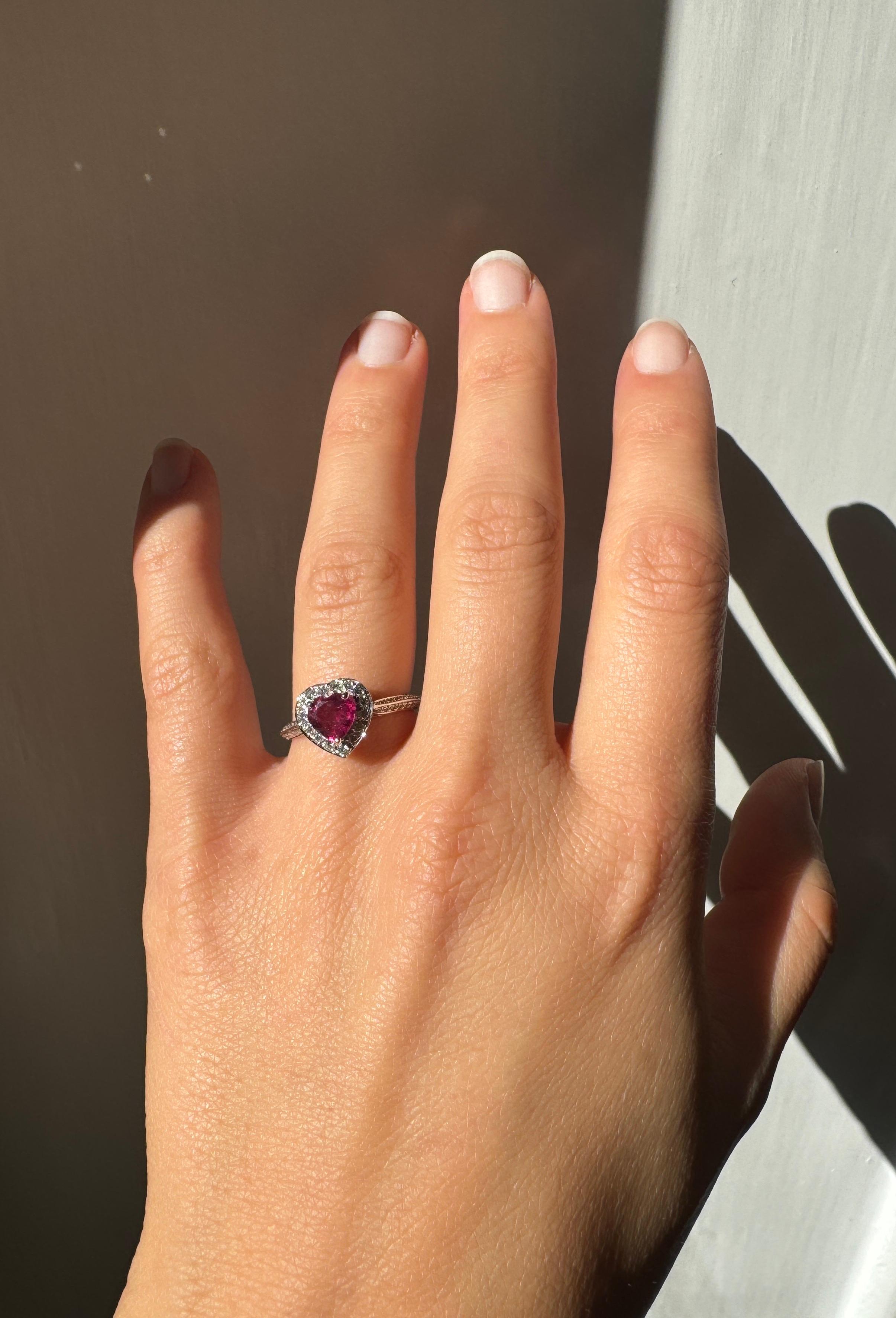 Rossella Ugolini 18K Gold Pink Tourmaline White Diamonds Engagement Ring. At its heart lies a stunning heart-cut pink tourmaline, a symbol of love and passion, encircled by a crown of sparkling white diamonds that beautifully follow the heart-shaped