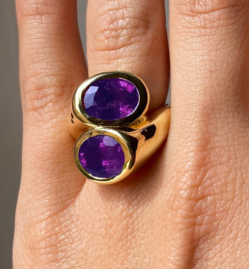 Rossella Ugolini design, Amethyst Cocktail ring 18K Yellow Gold.  The ring is very streamlined and smooth and has been crafted as a crossover, in solid 18K yellow gold with a polished finish. It is embellished with two natural Brazilian gemstones: