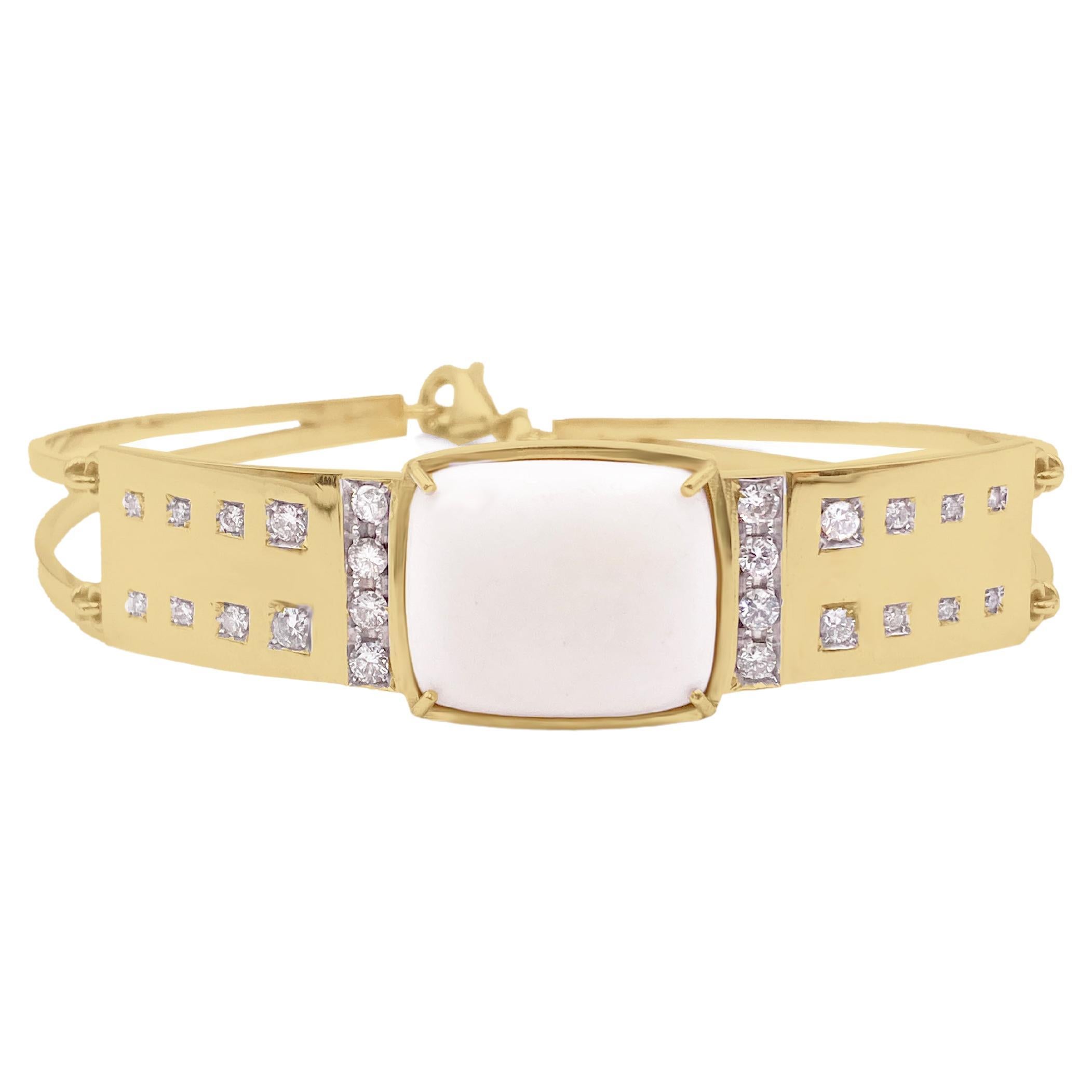 Rossella Ugolini 18K yellow Gold bracelet with  1.65 carats G color Vs1 White Diamonds. At its core, the bracelet features an 18K yellow gold plate that beautifully showcases a rounded rectangular white coral centerpiece. Adorning the sides of the