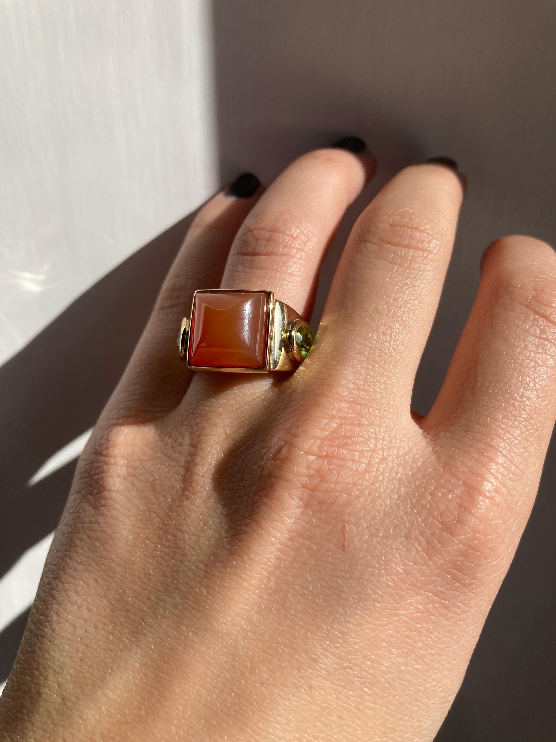 Rossella Ugolini Castle Collection 18 Karat Yellow Gold Orange Carnelian oval Peridot Unique Design Ring, 
Available in any size upon order within three weeks. 

Handcrafted in luxurious 18 karat Yellow Gold, this ring features a captivating
