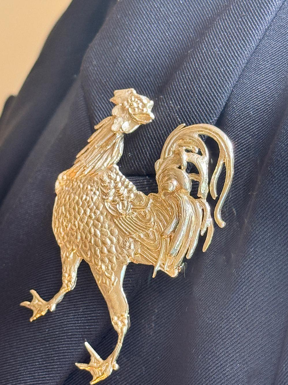 Rossella Ugolini design collection handcrafted masterpiece from Italy: a playful and dynamic Rooster brooch, meticulously crafted in bronze and plated in luxurious 24k gold highlighting the intricate feathers, evoking the lively spirit of a