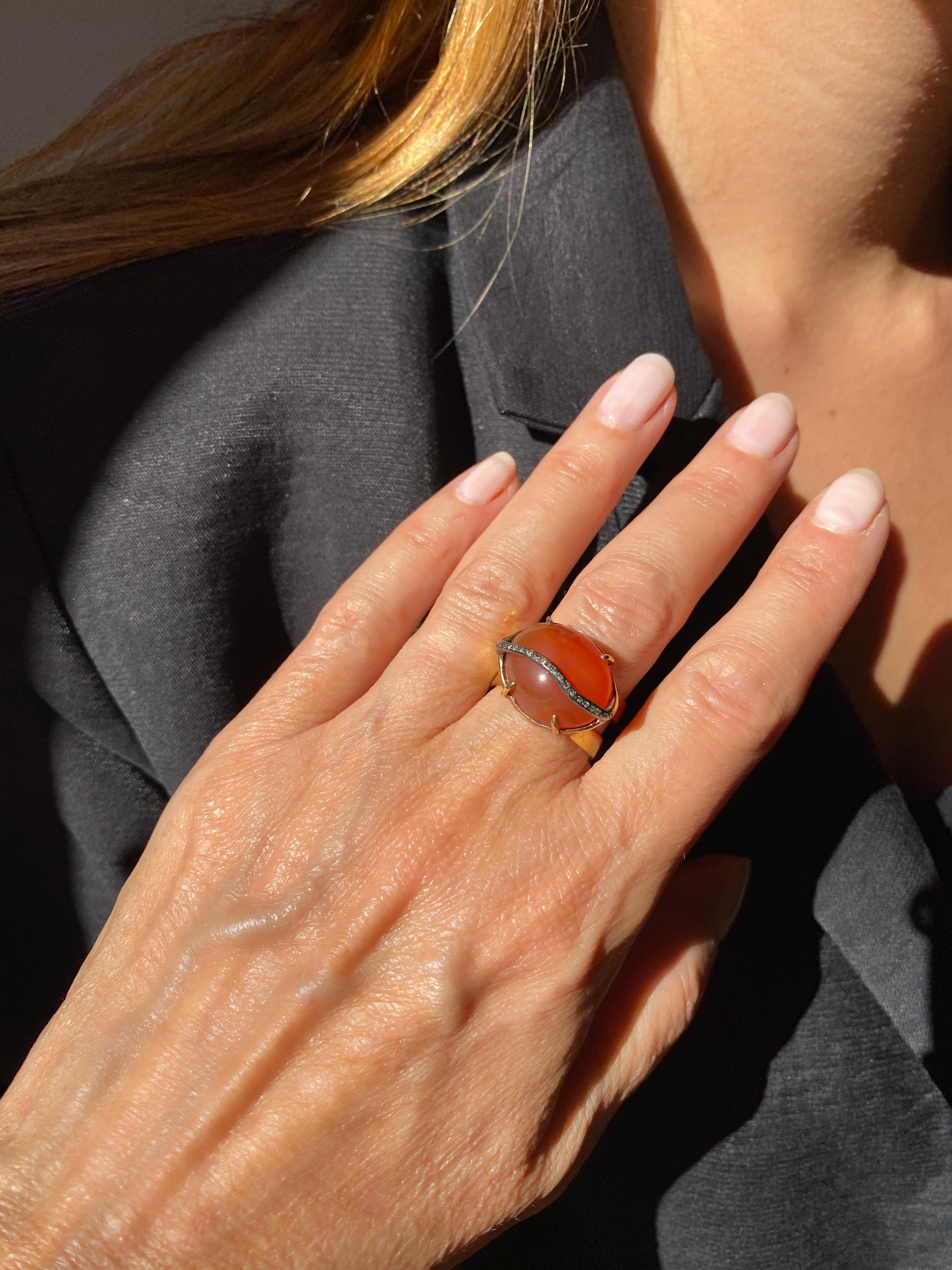 Introducing Rossella Ugolini's Bold Carnelian Ring, a captivating masterpiece handcrafted in Italy that seamlessly marries organic shapes with bohemian allure.

At the heart of this unique piece is an oval cabochon Carnelian  0,74in x 0,59in  ( 1,9