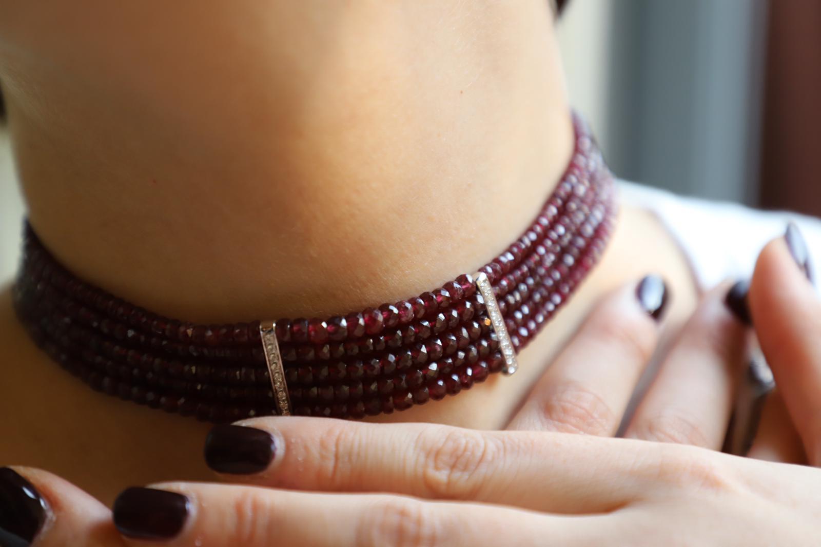 Introducing the Rossella Ugolini Choker: A masterpiece of Italian craftsmanship, uniting deep red Garnet beads with 18K white Diamonds. With 7 Garnet rows and front bars featuring 24 Diamonds, it blends classic elegance and modern allure. Clasp in
