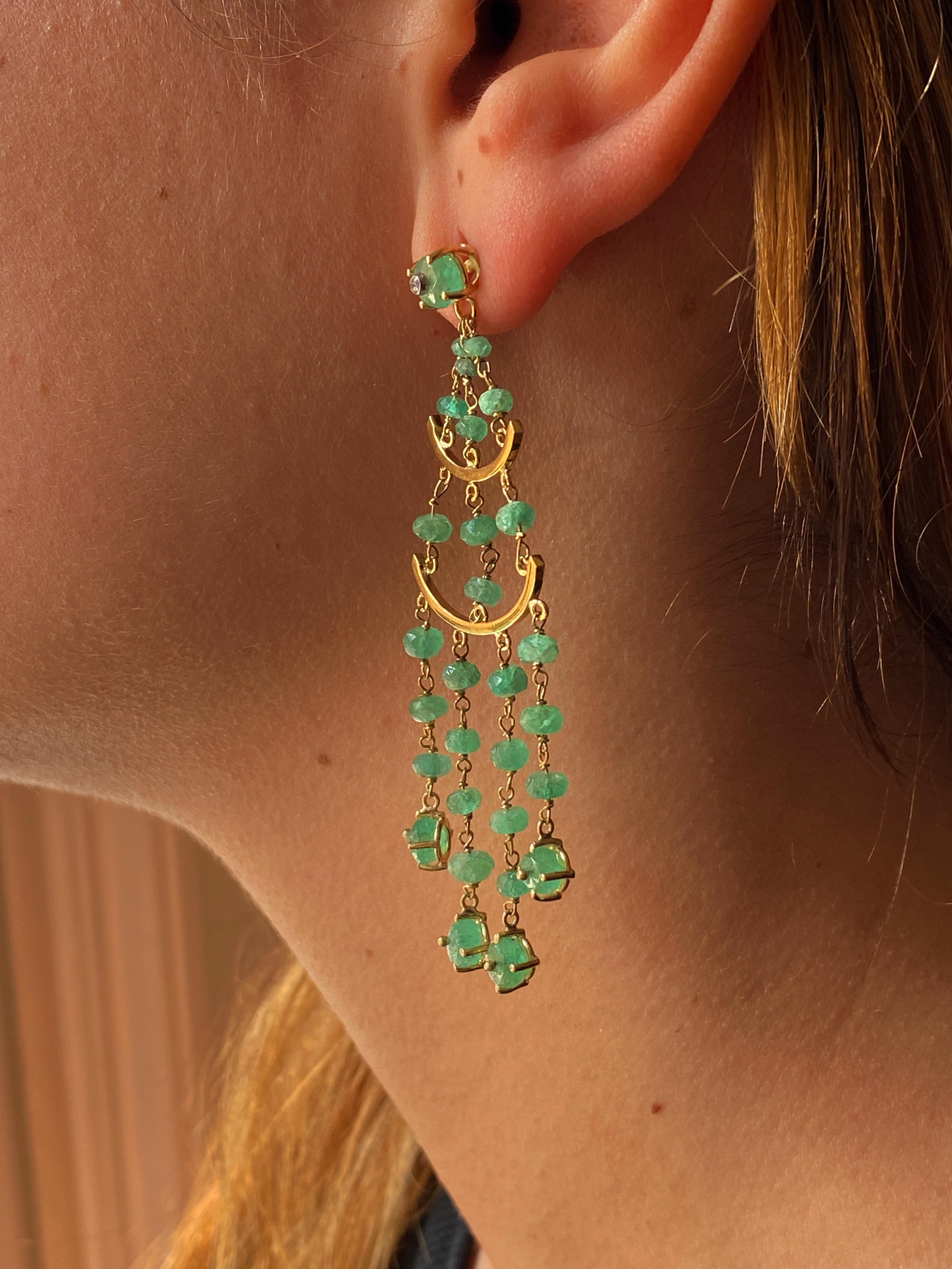 Introducing Rossella Ugolini's Exquisite Handcrafted Chandelier Emerald Earrings, a testament to the beauty of Italian craftsmanship. These mesmerizing earrings feature a cascade of 60 Emerald beads and Diamonds, meticulously crafted in 18k yellow