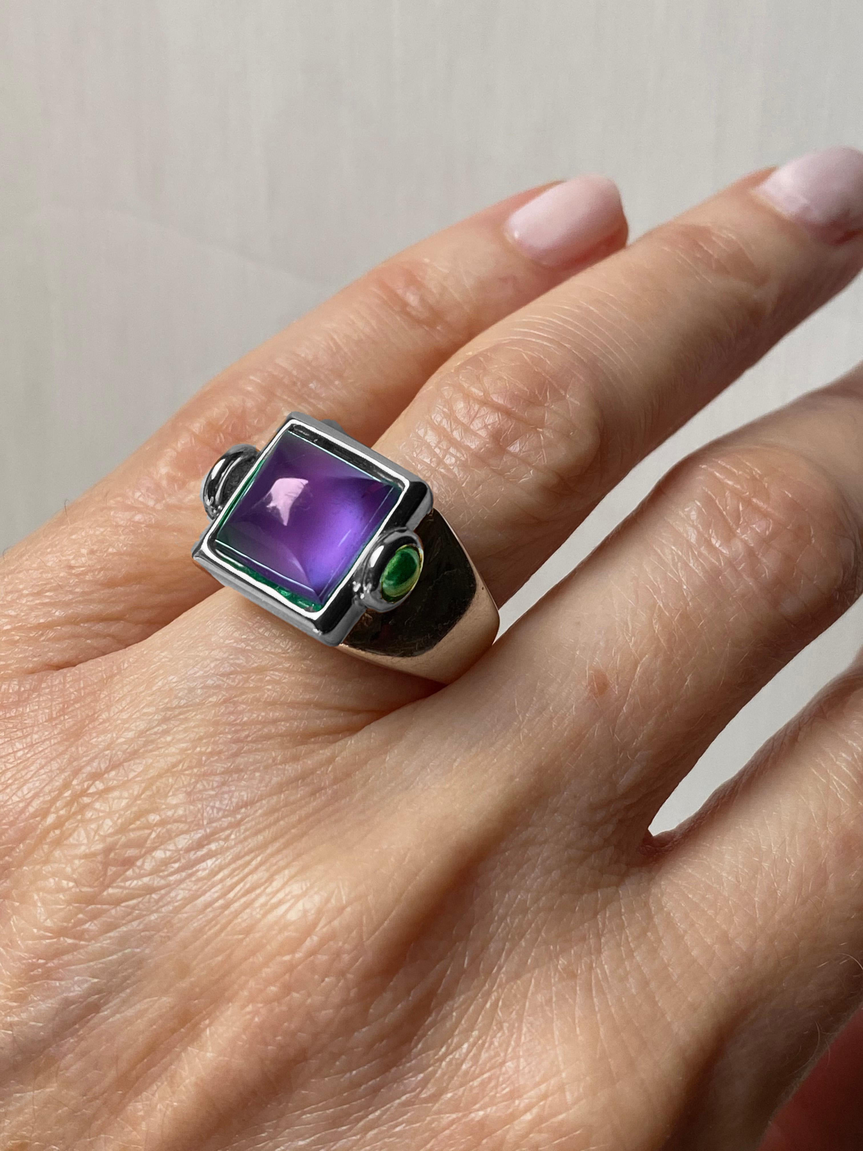 Rossella Ugolini's Castle of Italy design collection, meticulously handcrafted in Platinum featuring a striking Sugarloaf Cabochon Amethyst accented by two cabochon Green Emeralds . This exceptional Platinum craftsmanship, originating from Italy,
