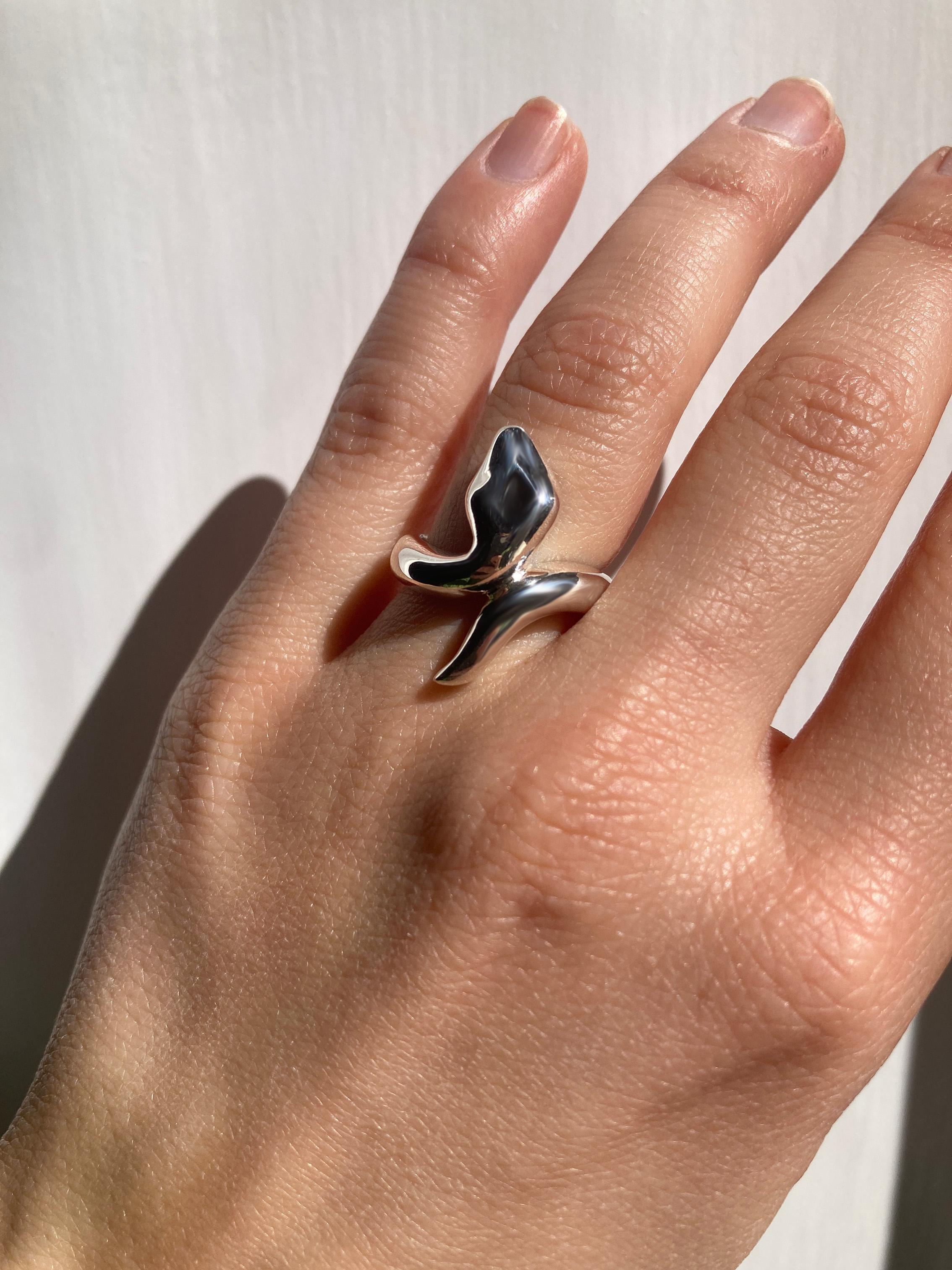 Rossella Ugolini Bold Snake ring, handcrafted in Platinum.
The sinuous form of the snake,  is coiled around the finger with its head and tail connected in a single line, imparting dynamic movement to the hand. 
Symbolizes resilience, transformation,