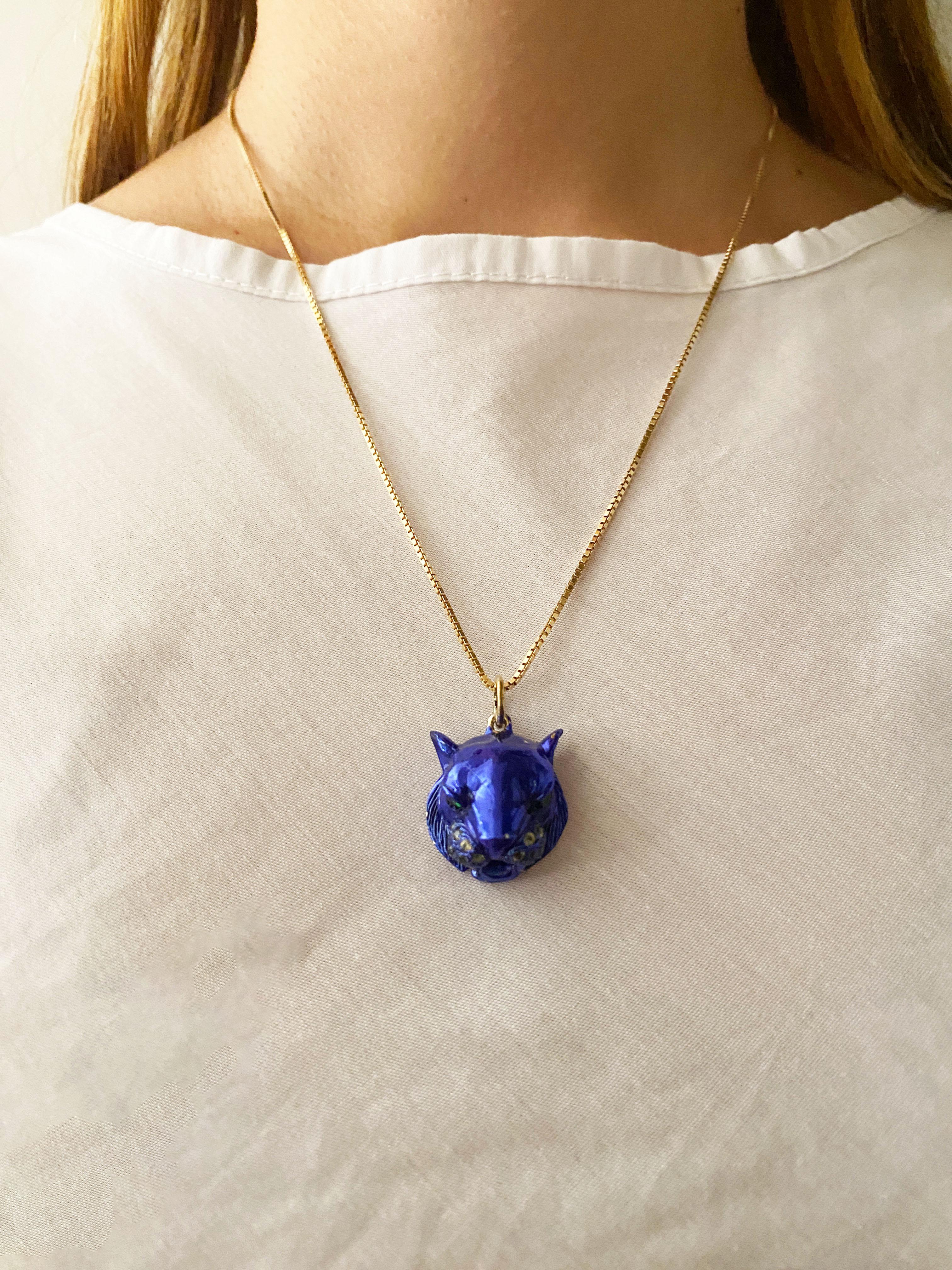 Introducing the Rossella Ugolini Unisex Blue Tiger Pendant a sterling silver and blue Ceramic masterpiece, handcrafted in Italy. This captivating pendant showcases a powerful tiger with green tsavorite eyes and a yellow sapphire-adorned mustache,