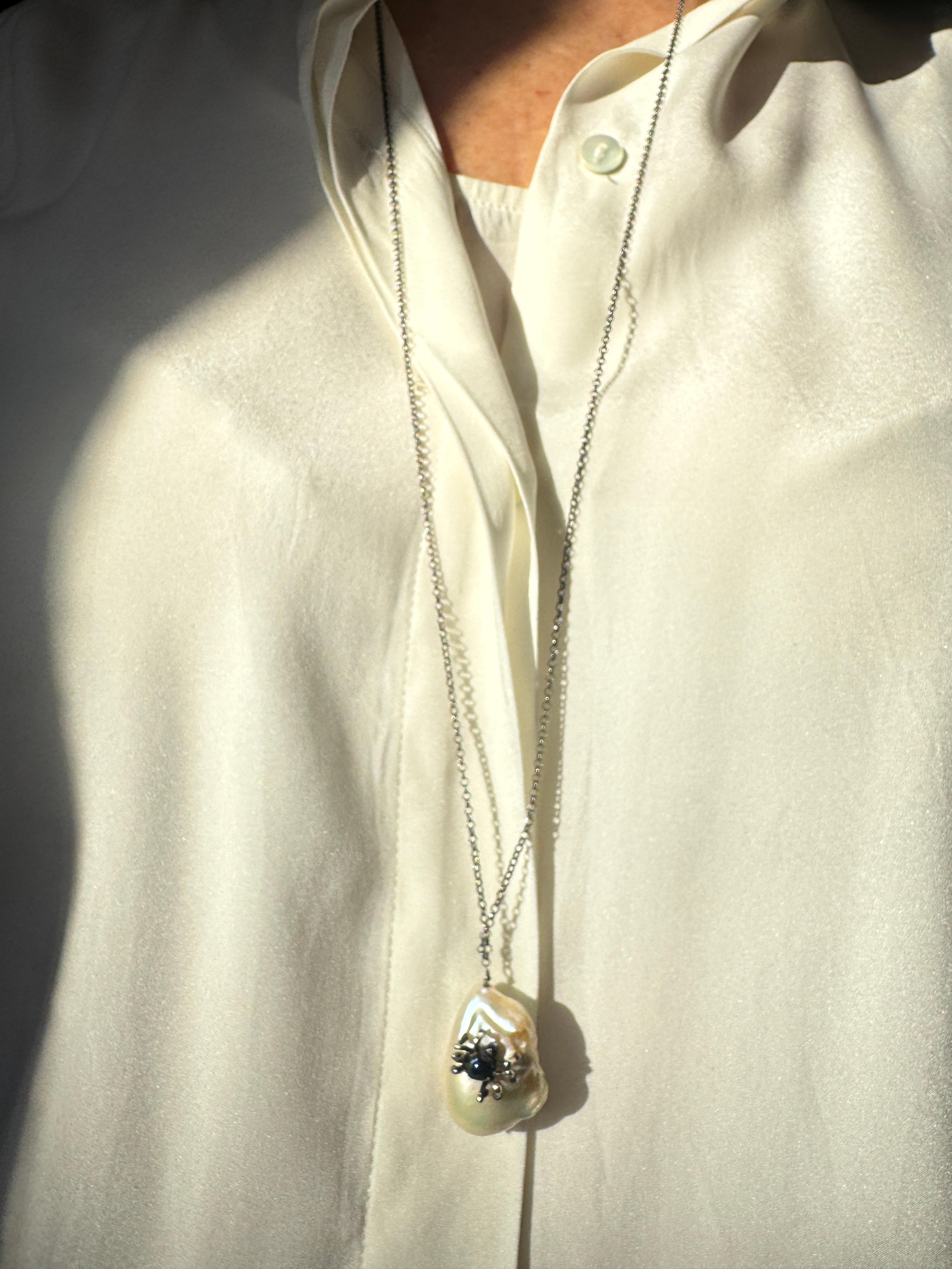 Rossella Ugolini Spider Blue Enamel Sterling Silver Unique Pendant Necklaces. A handmade Burnished sterling silver spider painted with blue enamel is set on a large white baroque pearl. 
measures : 31,5 inches (80 cm) in length
White Baroque Pearl :