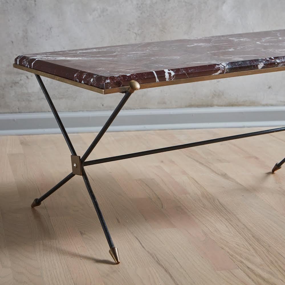 A handsome 1960s French coffee table in the style of Maison Jansen featuring a metal and brass frame with a new 1” thick rectangular Rosso Levanto marble tabletop. This marble has a beveled edge and a rich burgundy hue with beautiful white and gray