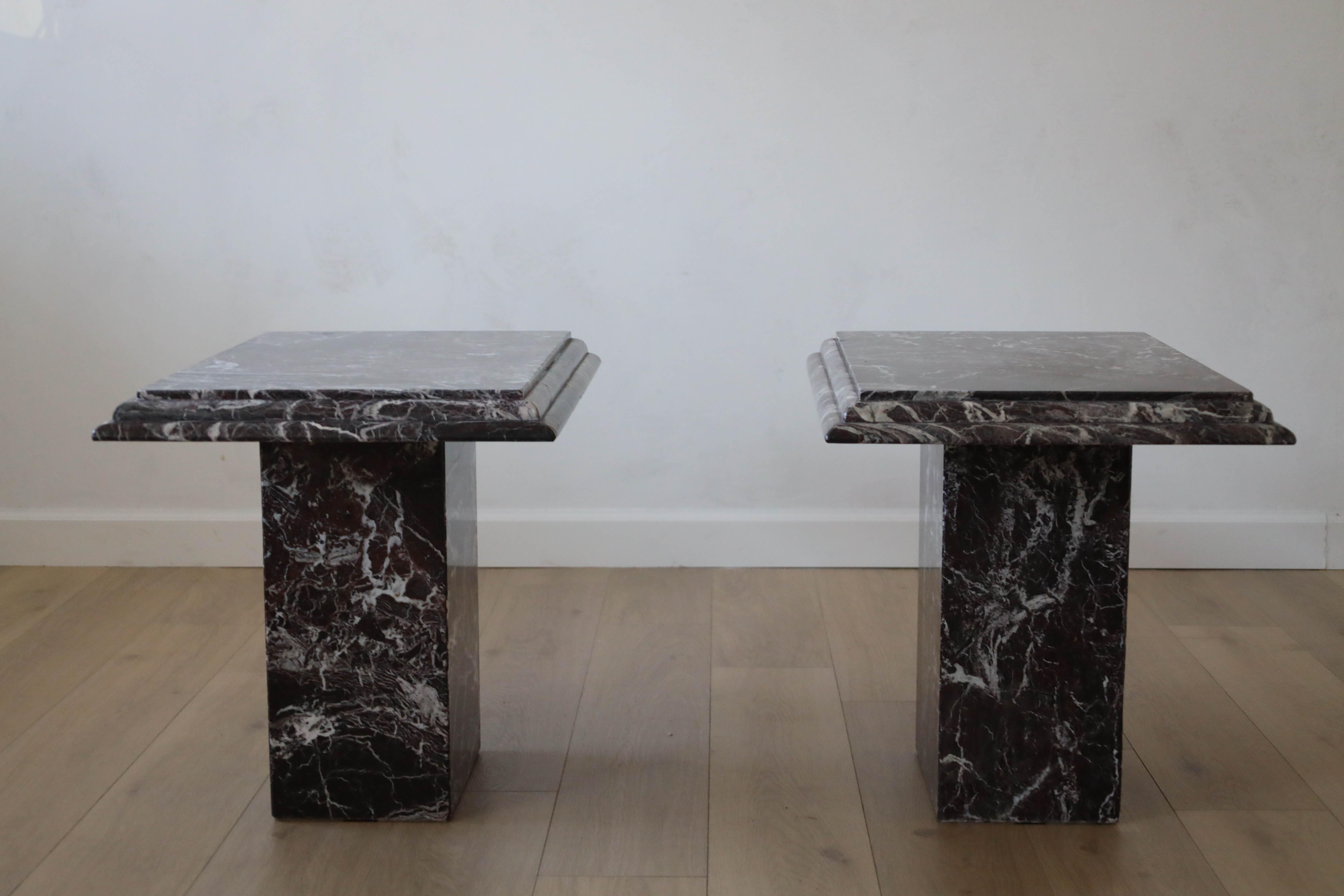 A pair of side tables constructed from Rosso Levanto Italian Marble featuring burgundy, white and black veining. These tables were custom made in Italy in the 1960s-70s. They have a pedestal base with a removeable top. The layered edges provide