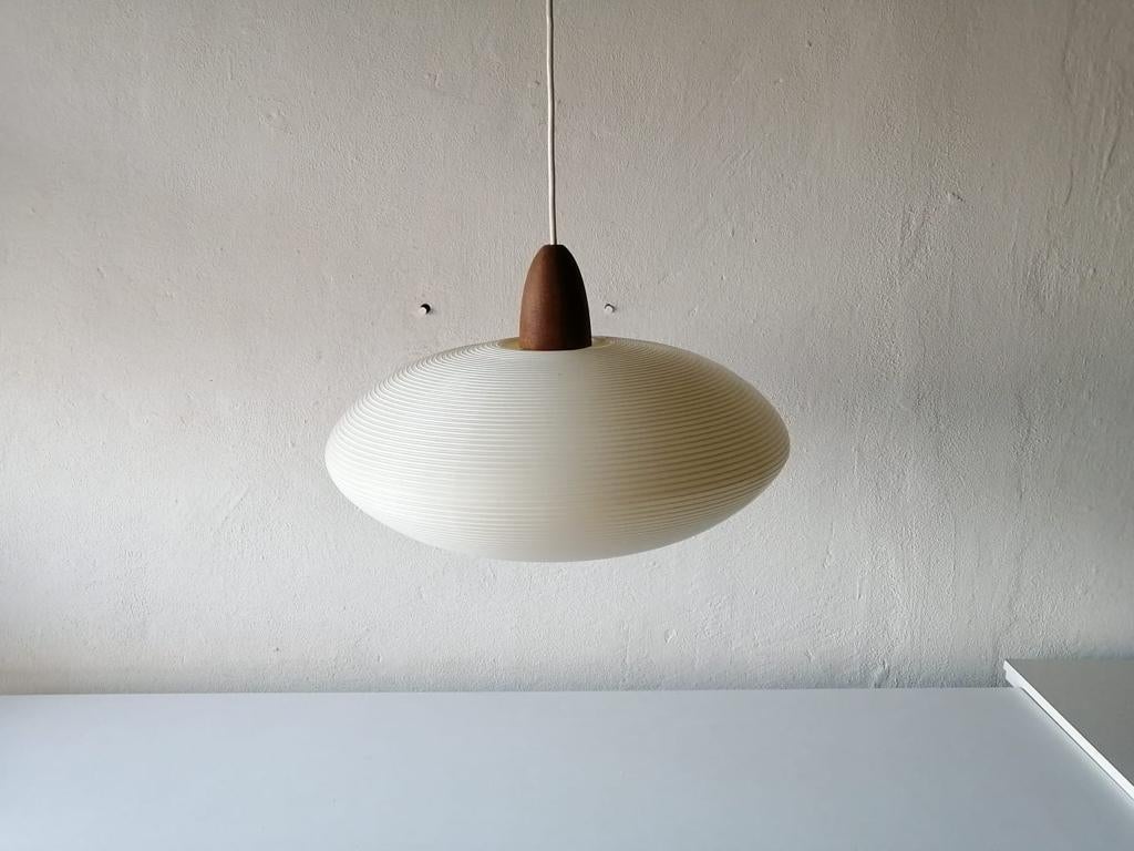 Mid-Century Modern Rotaflex pendant lamp by Yasha Heifetz, 1960s.

Elegant and minimal design hanging lamp

Teak parts and Abs plastic (rotaflex) lampshade
Lampshade is in good condition and very clean. 
This lamp works with E27 light bulb.