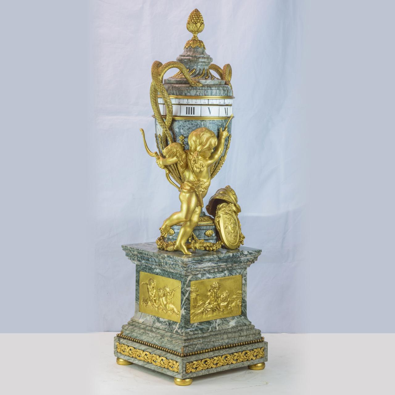 A Monumental Ormolu Mounted and Verde Antico marble rotary mantel clock in the manner of Jean-André and Jean-baptiste Lepaute

A fine large Louis XVI style gilt bronze mounted and verde antico marble rotary mantel clock in the manner of Jean-André