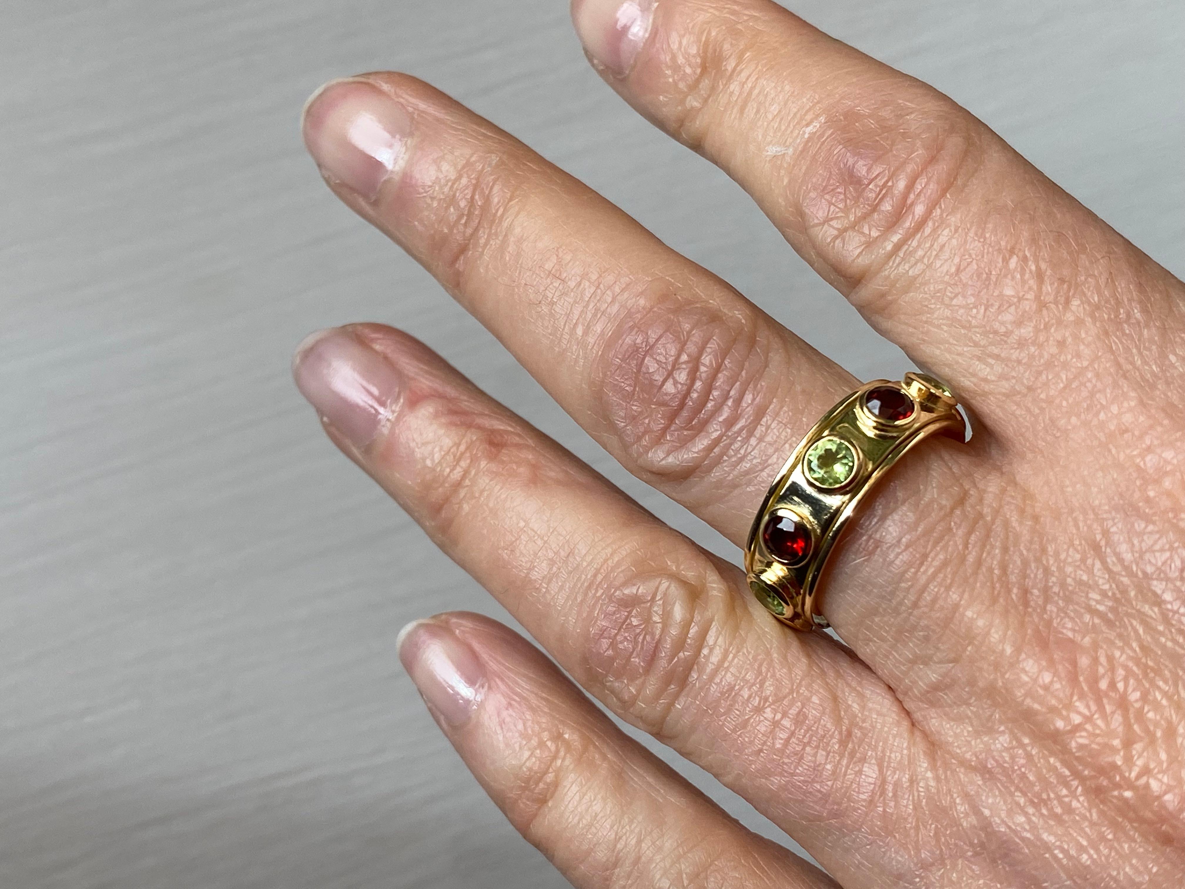 Rossella Ugolini design collection 18 Karats Yellow Gold Garnet Peridot Design Ring 
This is an amazing rotating cocktail ring is handcrafted in 18 karats yellow gold, adorned with peridot and garnet.
Garnet is often full of shiny, light reflecting