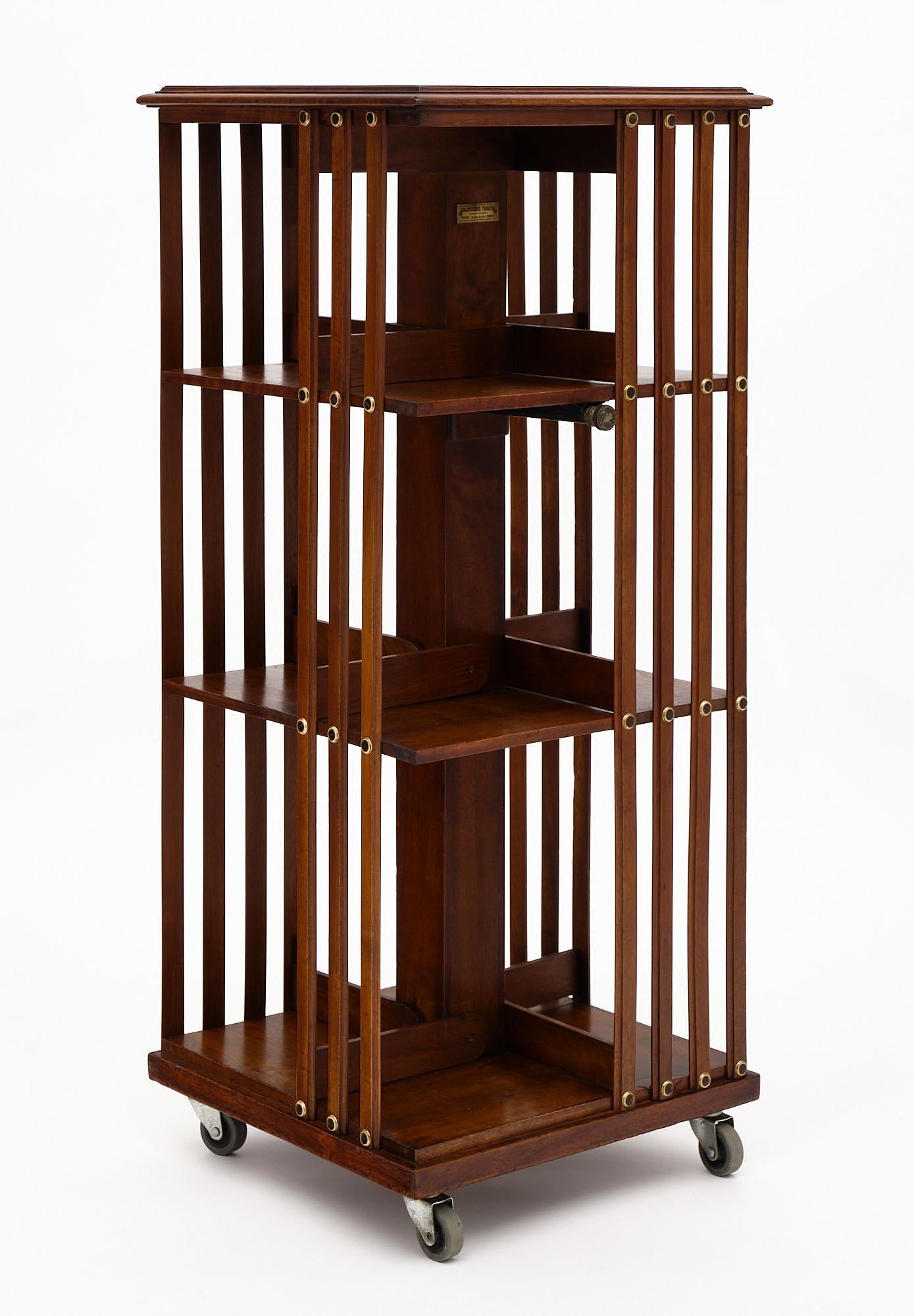 Rotating bookcase from France made of solid walnut on casters with three levels.