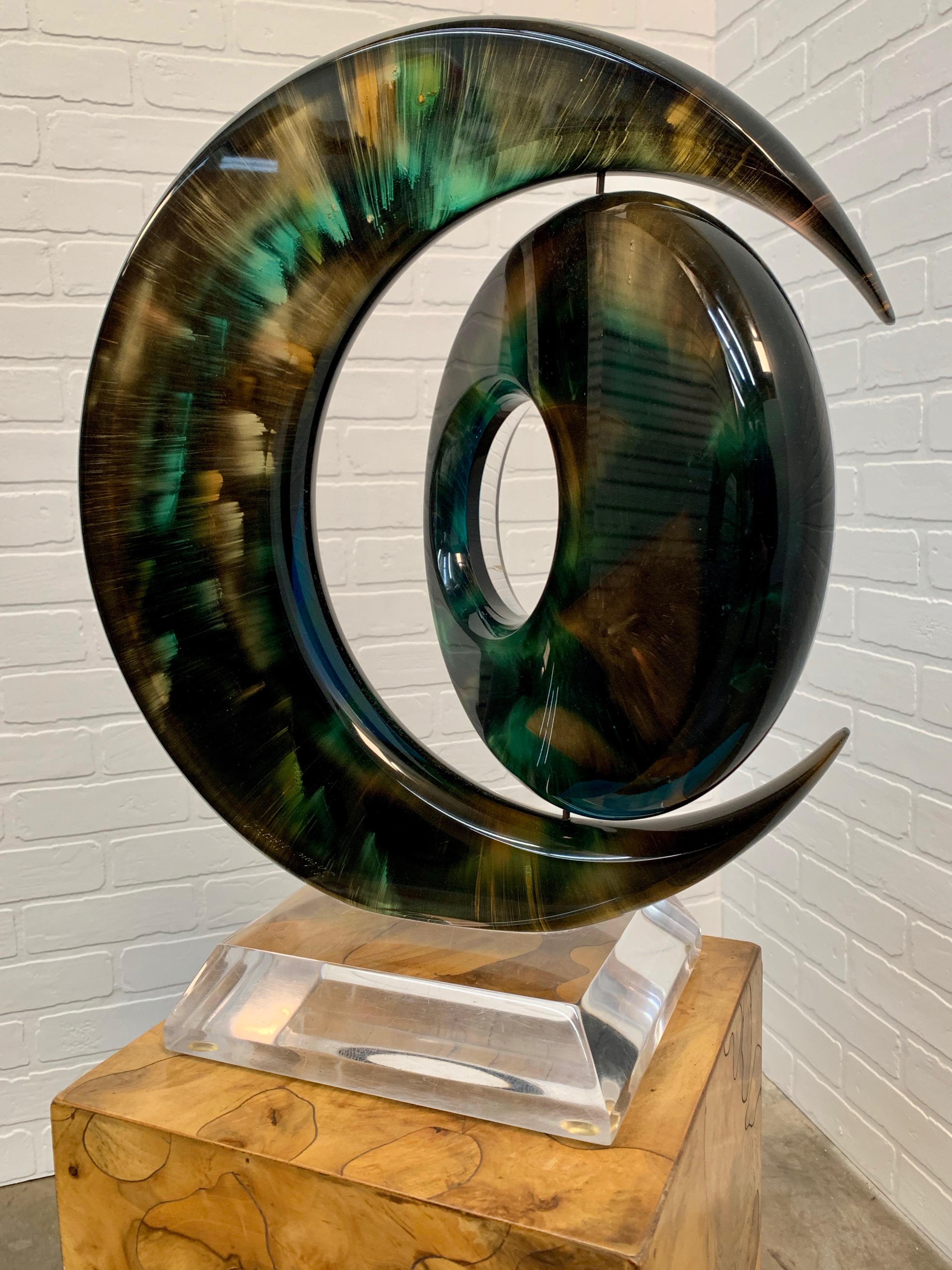 Rotating sphere within a crescent Lucite sculpture
Haziza started as a painter and later began to explore new mediums. He ran a small studio in his hometown. Later on he started his journey to Los Angeles. Which in turn, presented a leading art and