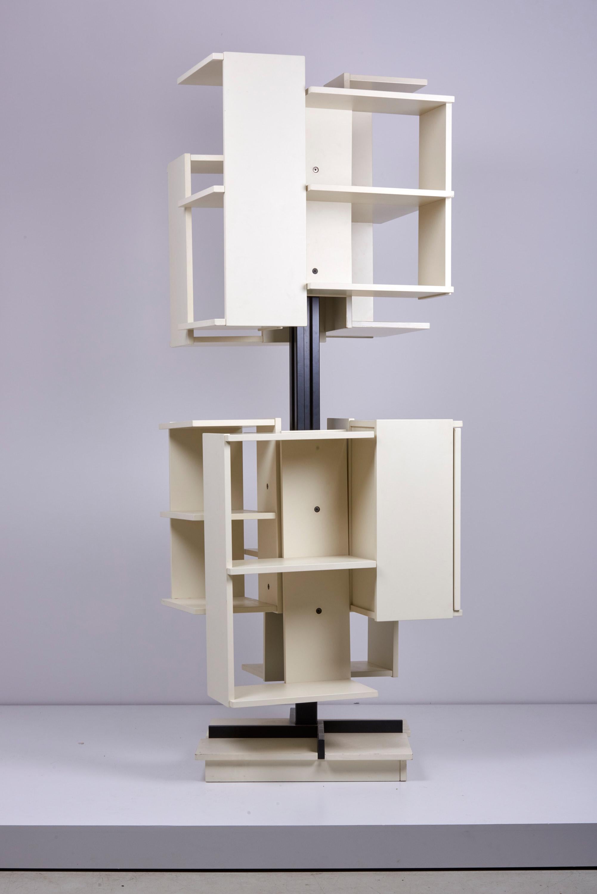 Rotating high bookshelf with seven open and one close storage compartments.