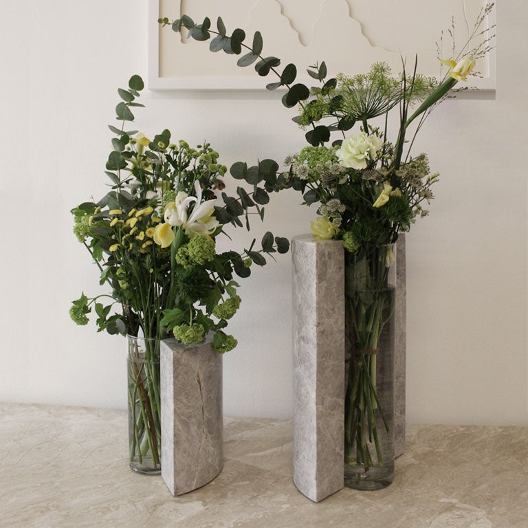The ROTONDO VASE is a masterpiece of design that revolutionizes the very essence of what a vase can be. Meticulously crafted from exquisite marble, its sleek geometric forms and pure lines create an enchanting marble frame that embraces the flowers