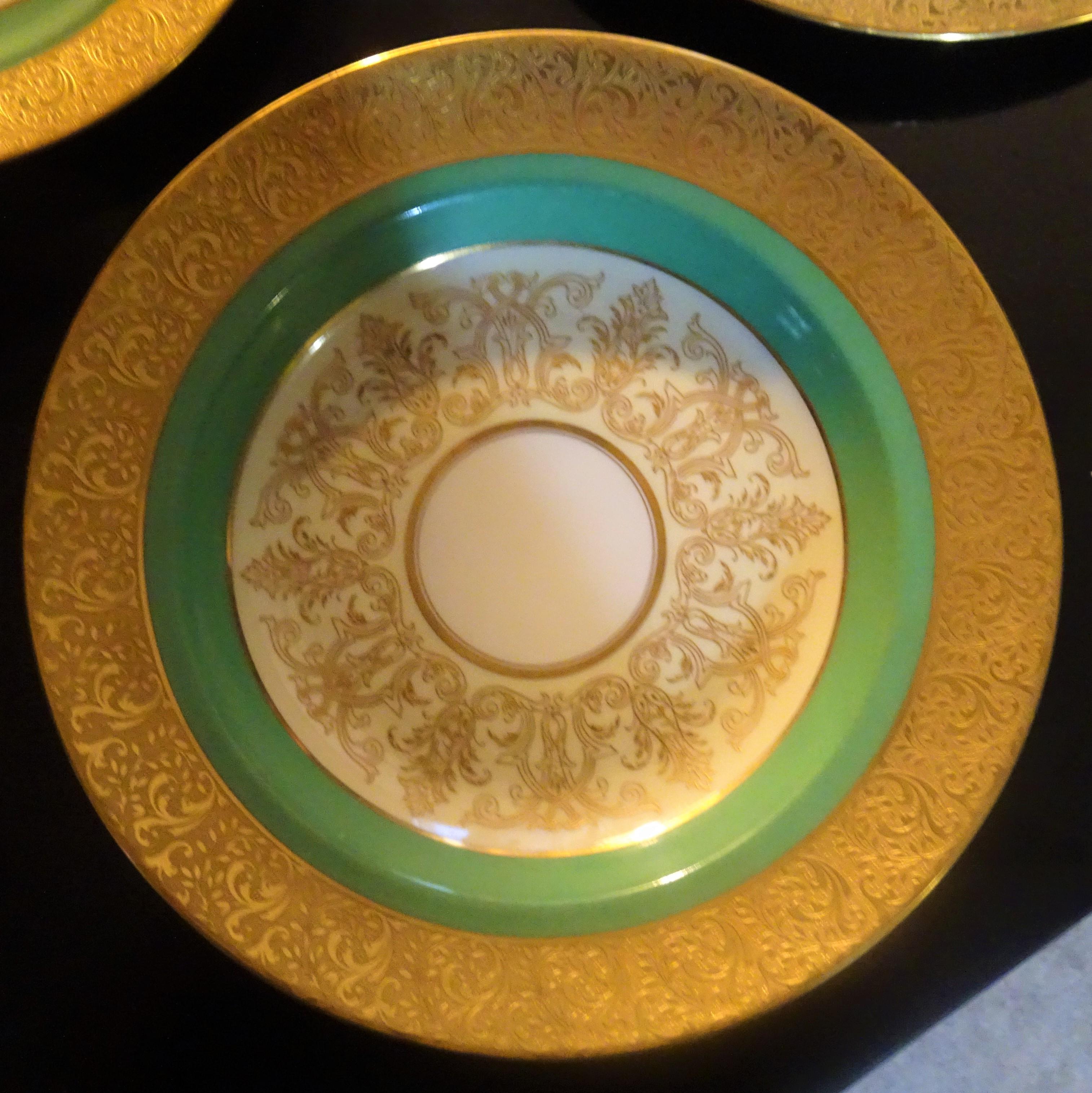 This set of hand-decorated Limoges porcelain consists of four dinner plates (10.5