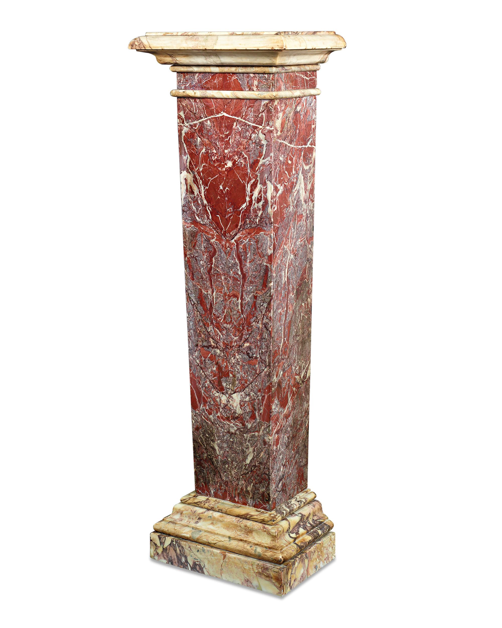 This elegant Italian pedestal is hewn from a striking piece of Rouge de France marble. Quarried only in France, Rouge de France marble has been hotly sought-after since ancient times for the highly varied, vibrant colors and patterns that naturally