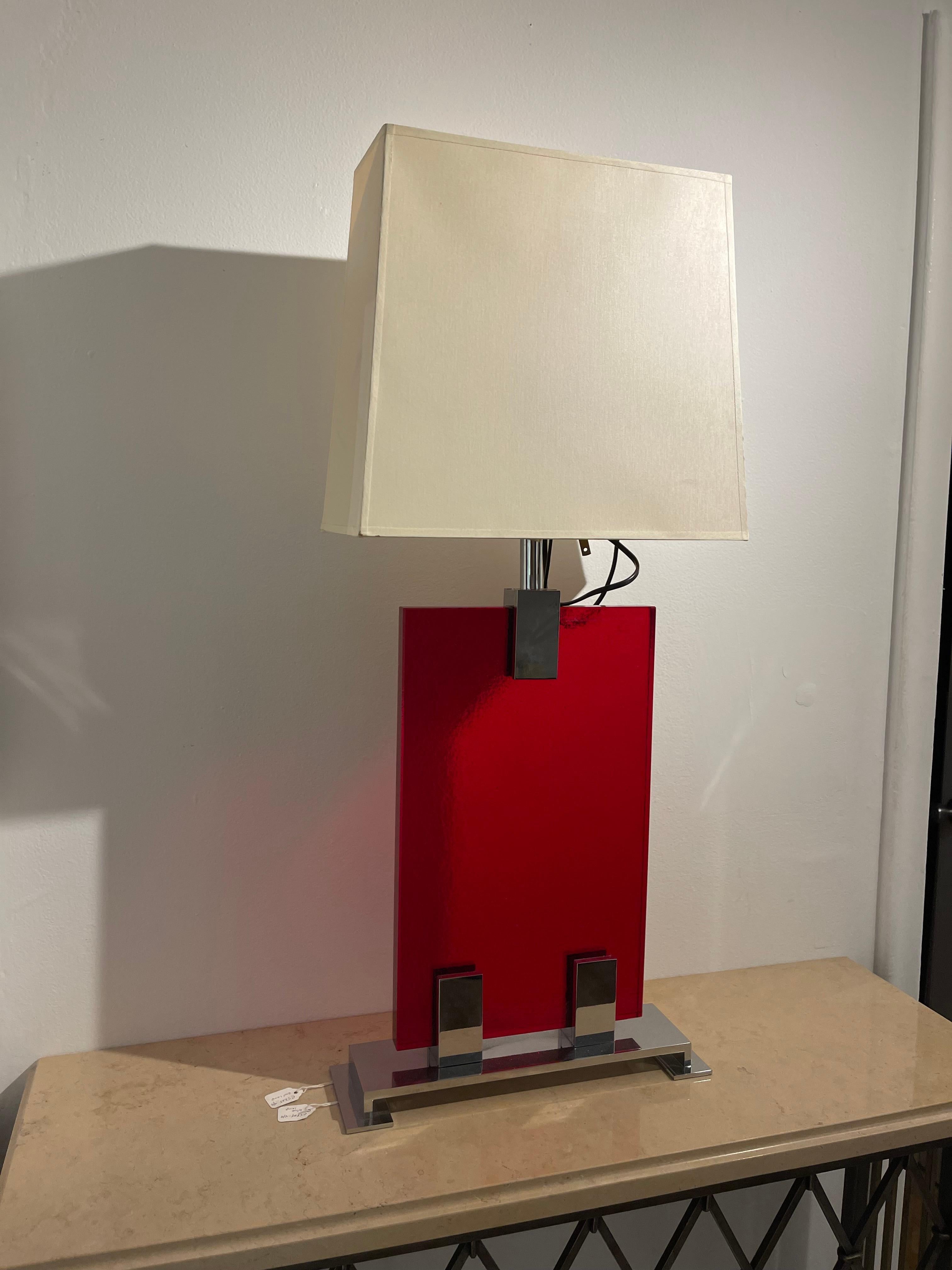 Fabulous mid-century red glass table lamp with an Art Deco flair and very streamlined, chromed details.
