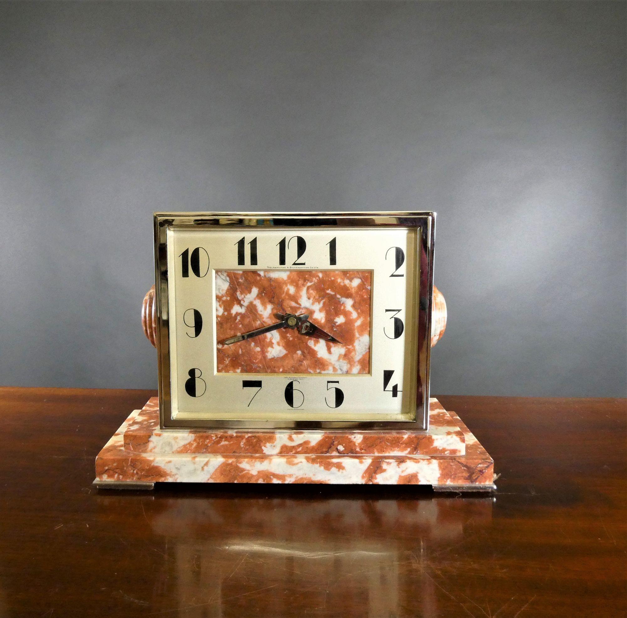 Rouge marble and chrome Art Deco mantel clock, goldsmiths and silversmiths, London
 
An unusual Art Deco mantel clock housed in a finely figured rouge marble and chrome case with raised, stepped plinth and resting on four chrome pad feet with