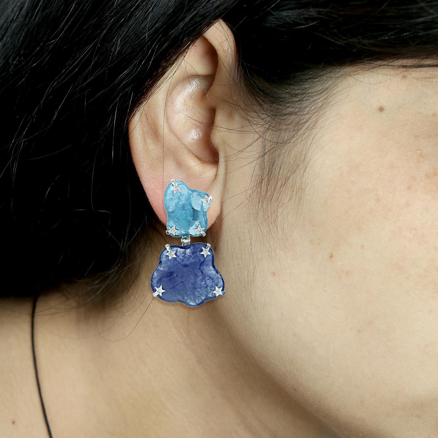 One of a kind this free-form Aquamarine & Tanzanite Earring in 18K white gold with star diamond motifs is like carrying those clouds around you. It's just majestic.

18KT: 11.655gms
Dimond:0.25cts
AQUMARINE: 54.97cts
TANZANITE: 53.76cts