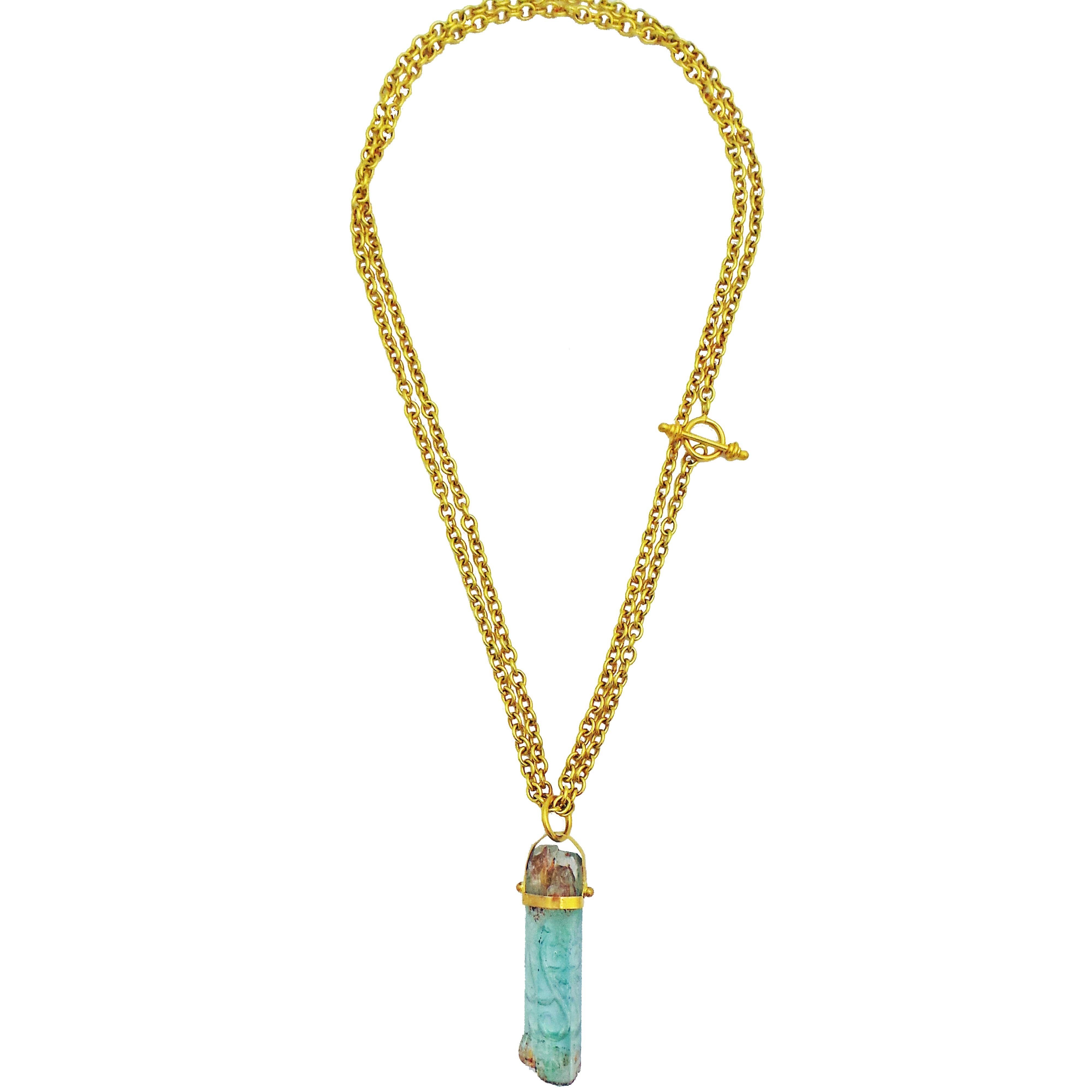 Rough Aquamarine crystal with reverse intaglio filigree vine carving set in a hand-forged 22k yellow gold pendant. Solid 22k yellow gold cable chain necklace is convertible, and can be worn long at 34 inches or doubled through the pendant's bail to