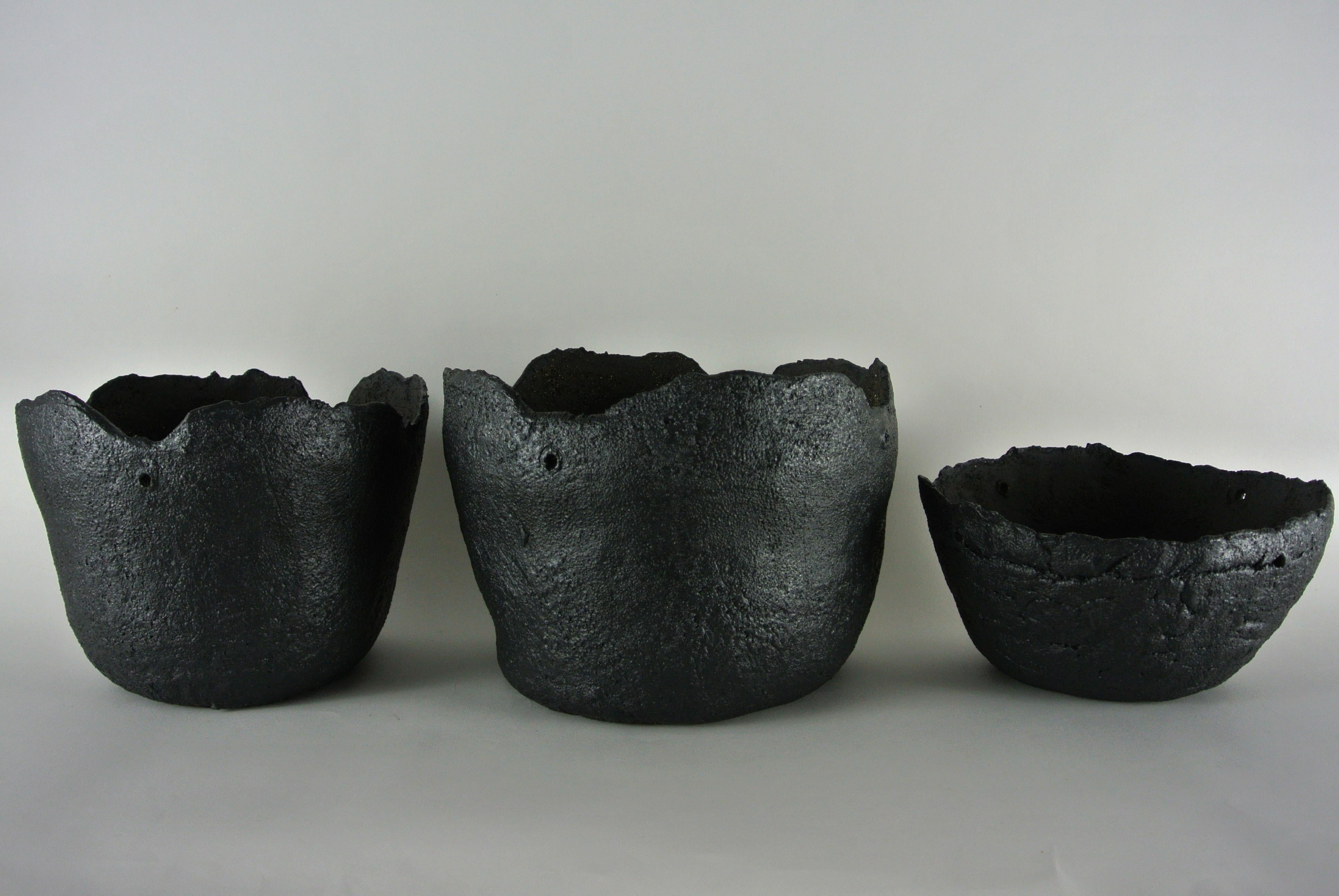 Asymmetric black stoneware planter with black metallic glaze. Unglazed on the inside and with holes along the top edge to hang from the ceiling.
Comes in a variety of shapes and sizes and material.