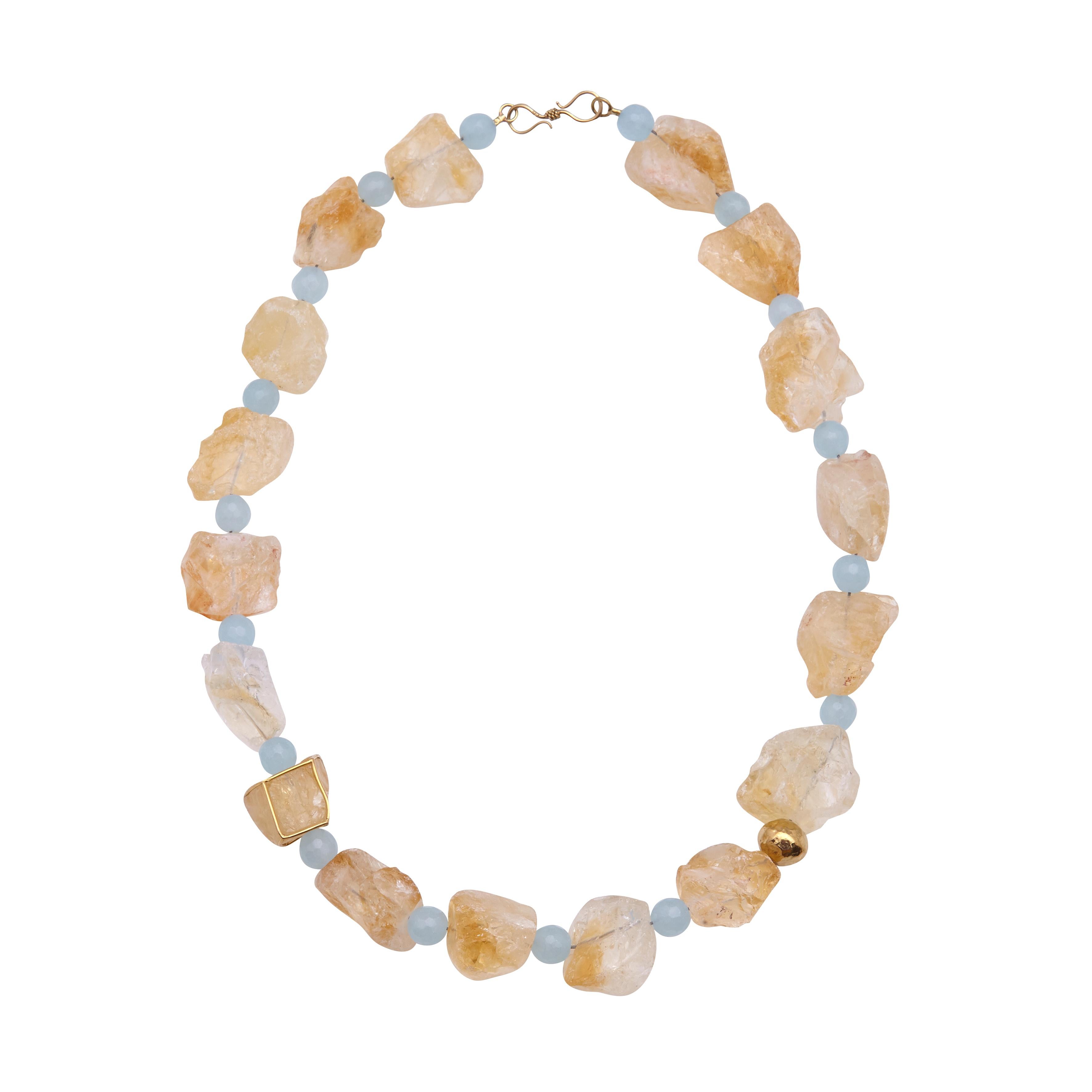 A unique necklace, handmade in 18Kt yellow gold, with raw citrin and jade.One of the raw citrine is closed in a golden cage and a jade is released by a hammered 18kt gold  bead.  A piece of jewelry, that makes a serious statement to your outfit and