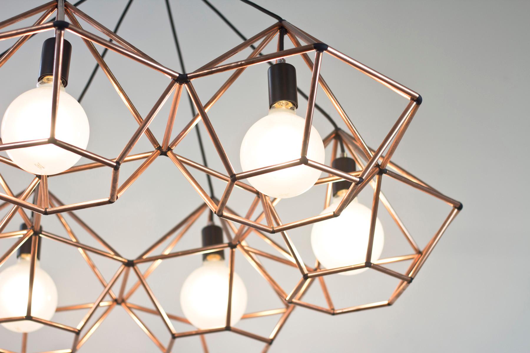 Rough diamond chandelier is a decorative fixture that combines handmade craftsmanship with digital technology. The design combines a 3D printed joining system with handcut and assembled copper or brass tube. The result is a decorative feature light