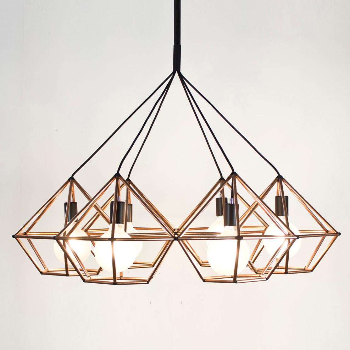 Rough diamond chandelier is a decorative fixture that combines handmade craftsmanship with digital technology. The design combines a 3D printed joining system with hand cut and assembled copper or brass tube. The result is a decorative feature light