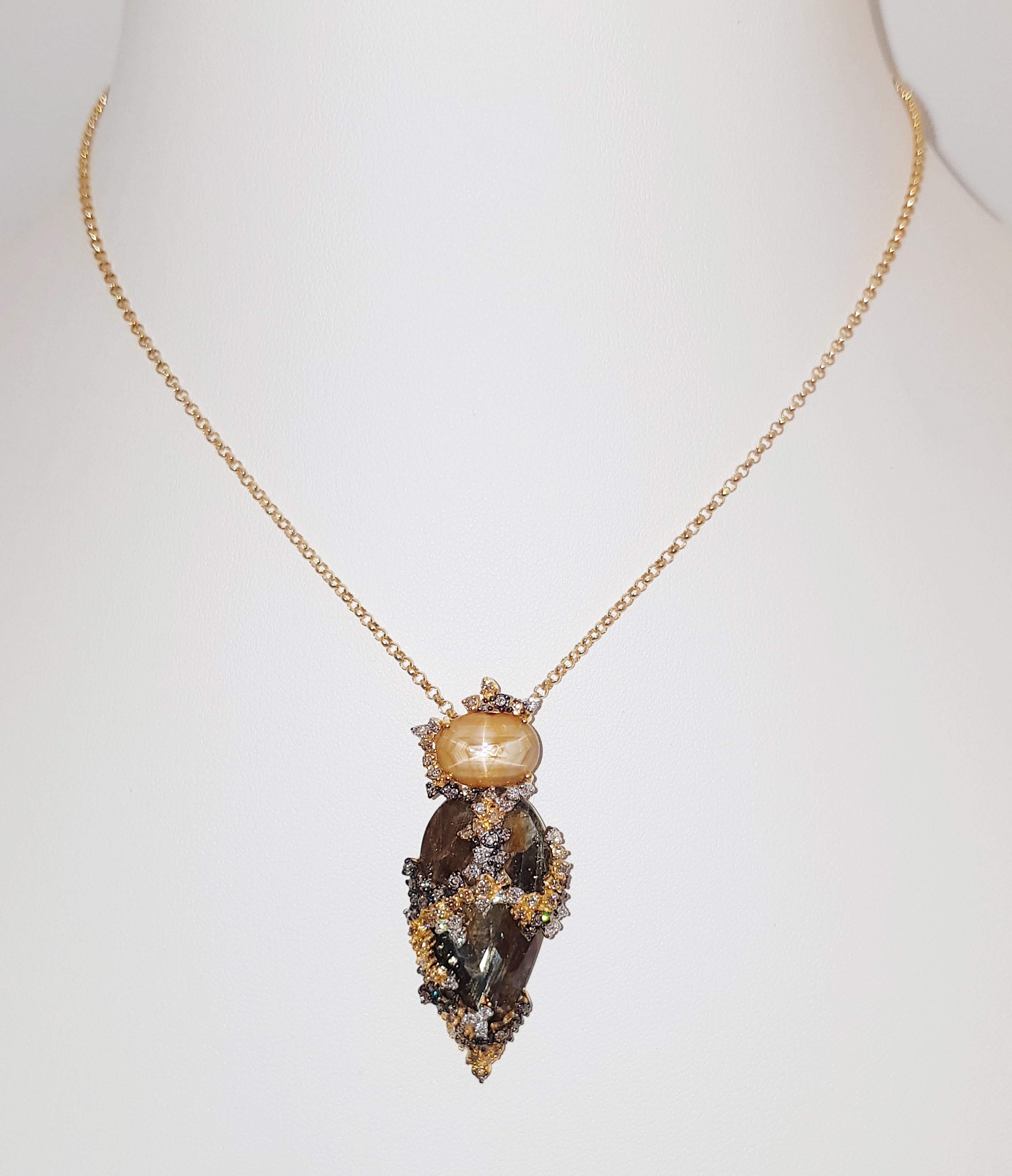 Rough Sapphire 27.89 carats, Yellow Star Sapphire 6.97 carat, Brown Diamond 0.73 carat and Diamond 0.29 carat Pendant set in 18 Karat Gold Settings
(chain not included)

Width: 2.1 cm 
Length: 5.0 cm
Total Weight:  grams

