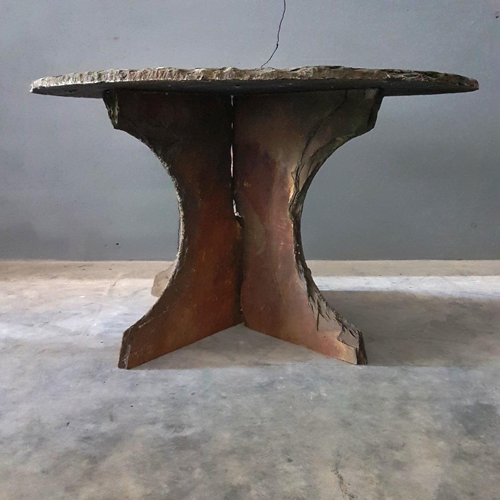 Rough slate stone terrace or side table, 1950s

A round rough slate garden table or side table with a slate base which consists of two parts.
With beautiful patina, colors, relief and moss remnants.
The table leg parts can be pushed together and