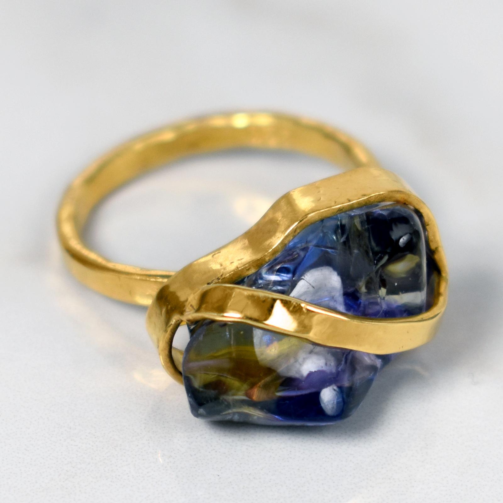 Polished, rough cut Tanzanite set in a hand-forged, 22k yellow gold ribbon cocktail ring. Size 7. Gorgeous gemstone in a minimal, contemporary ring.