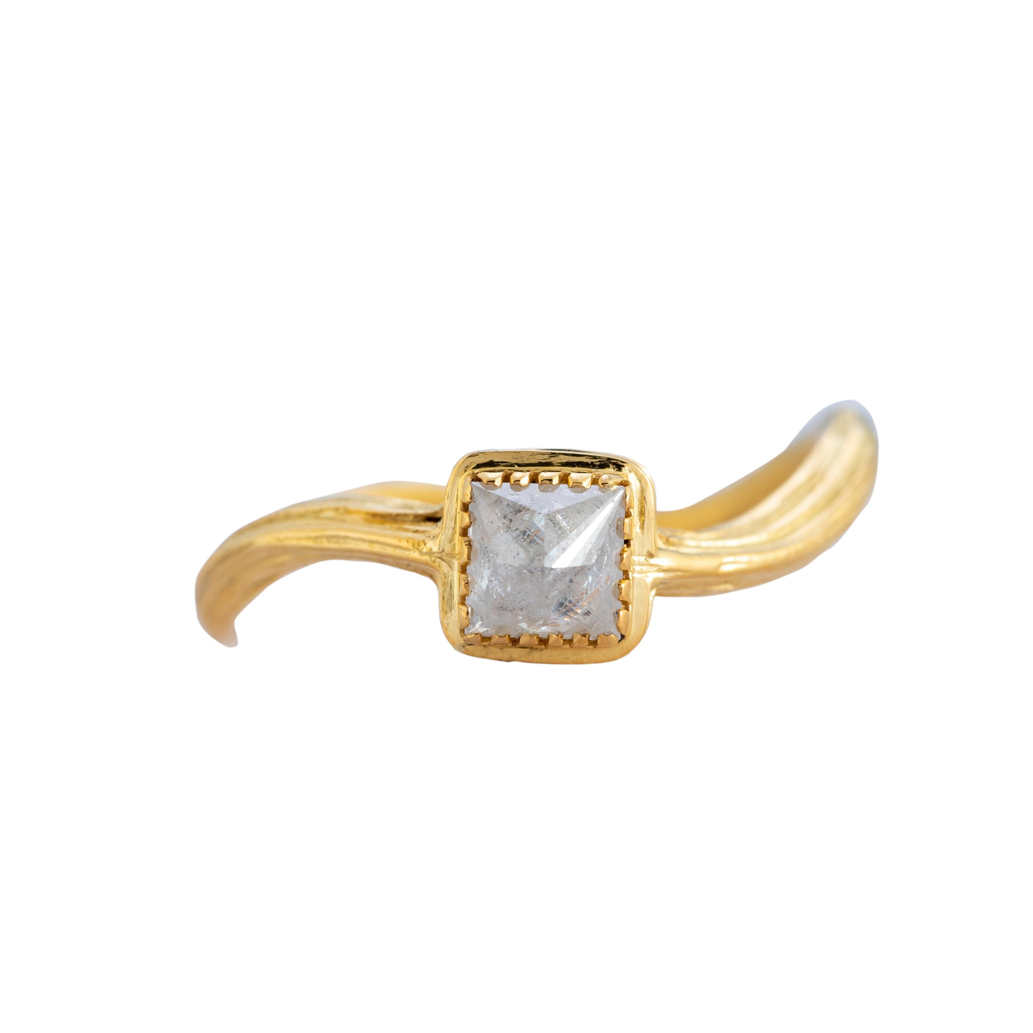 A one-of-a-kind diamond ring which has been handmade in our workshops. The central rough cut diamond is set in 18ct gold and has a lightly textured shank.

This would be a perfect engagement ring or a ring for any diamond lovers out