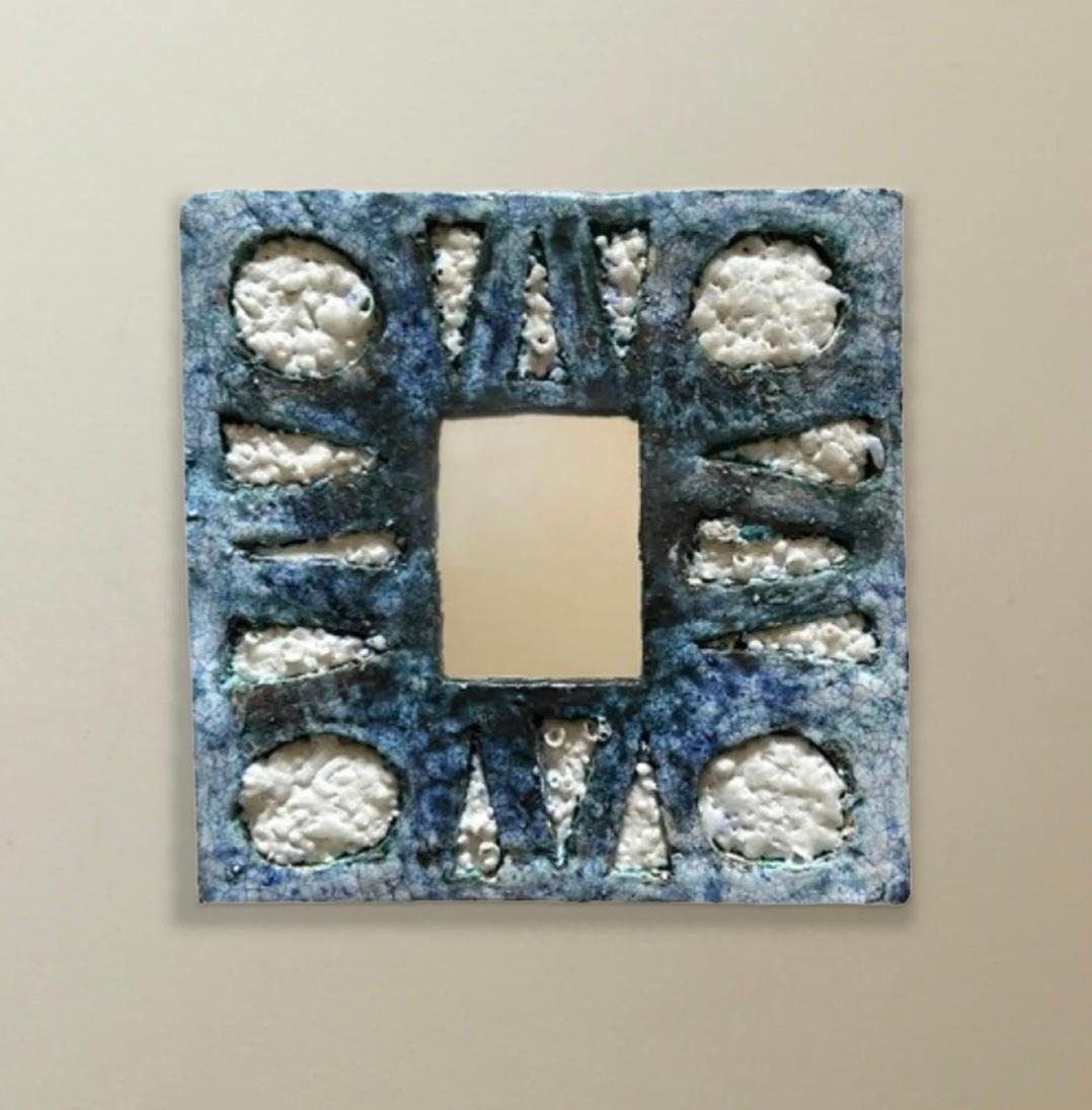 Roughly textured earthware with a pattern of circles and diamonds. French 1960s.
Dimensions: 21.5cm Square, wired for wall mounting.